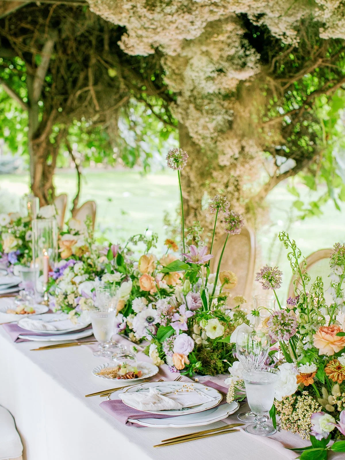 Wildflower-inspired tablescape with handmade paper menus, purples, peaches, butter yellows at Boulder Flower Farm