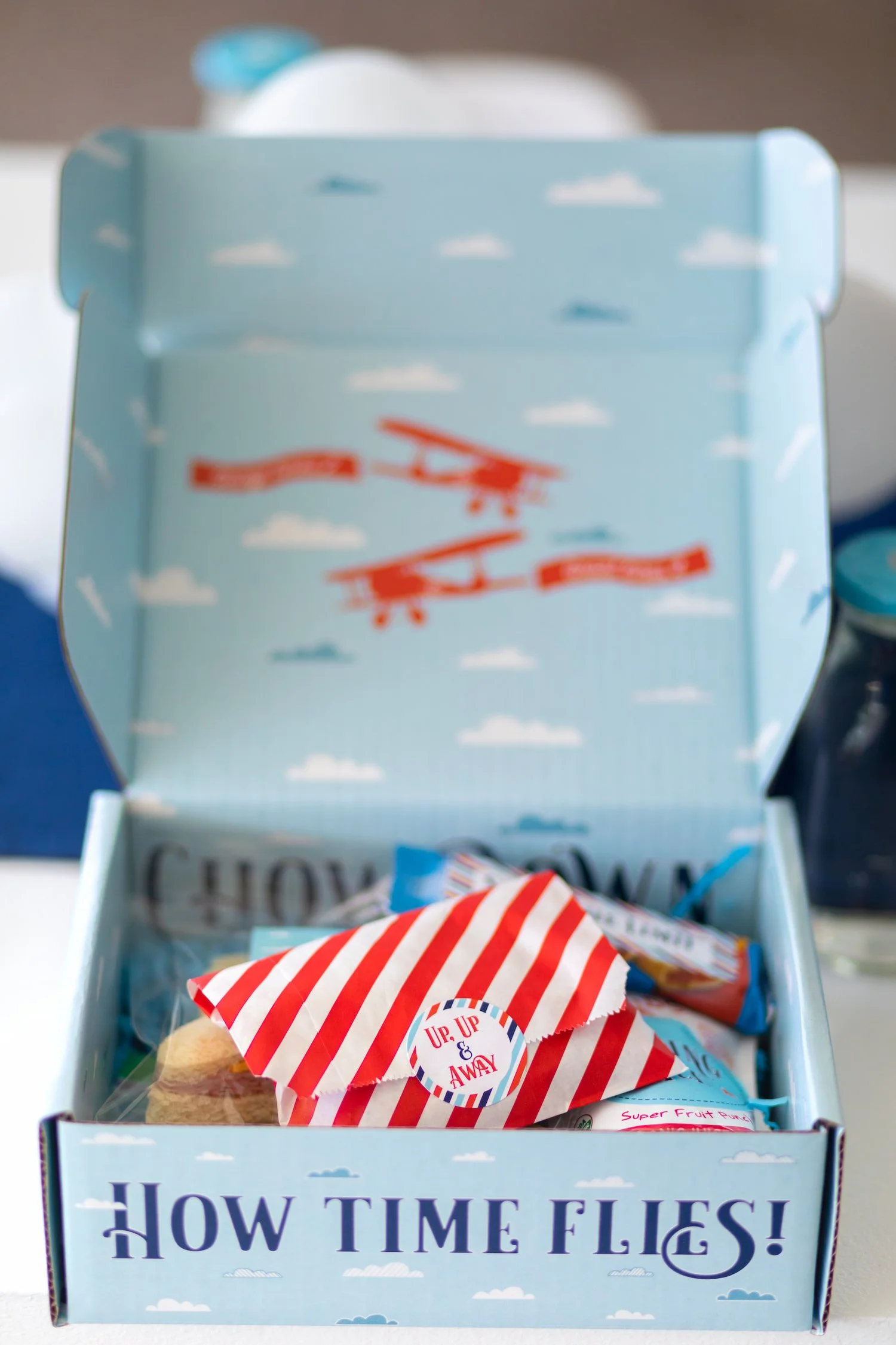 Red, white, and blue airplane birthday party featuring aviation-themed decor, custom lunch boxes, and playful details for a two- and four-year-old celebration.