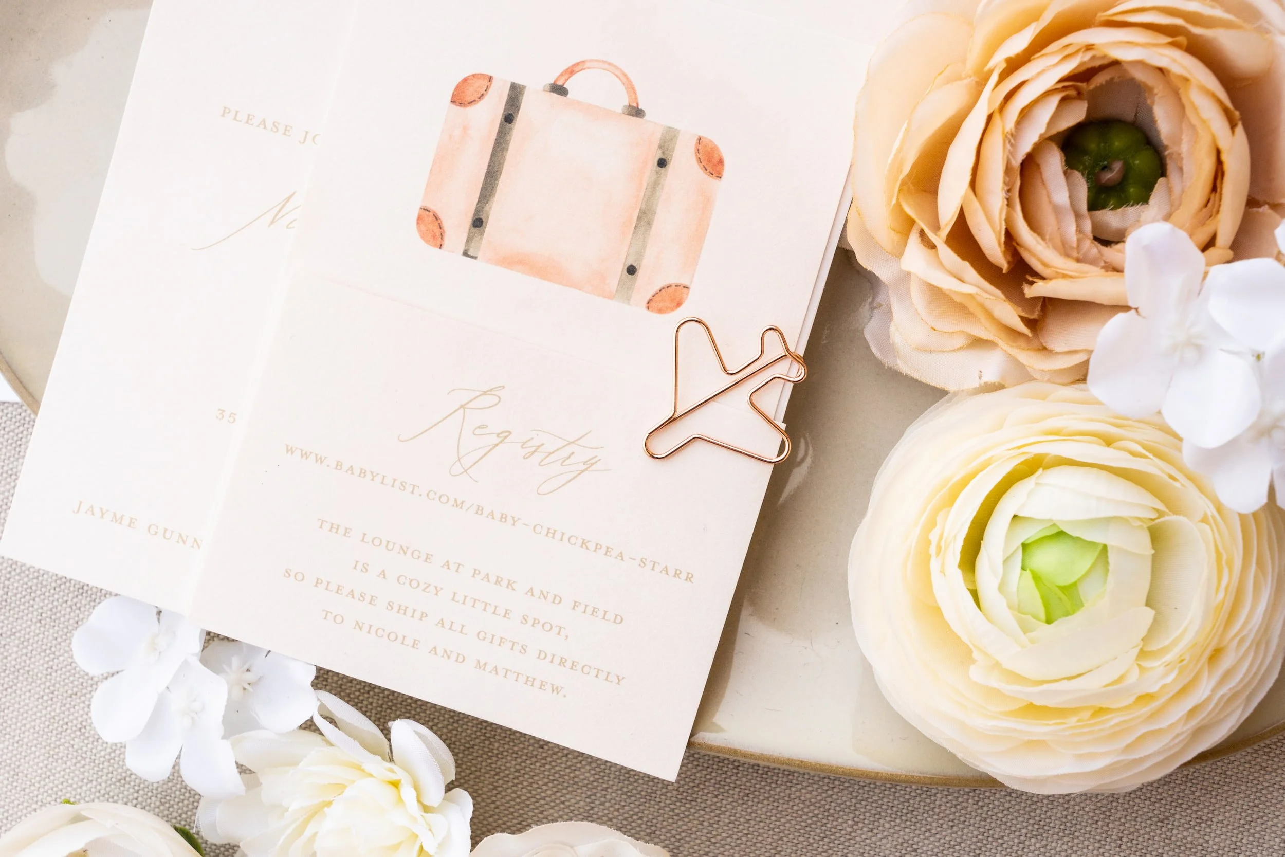 Baby shower registry card featuring coordinating peach and sage watercolor artwork with travel-inspired design elements and modern typography directing guests to the couple's gift registry.