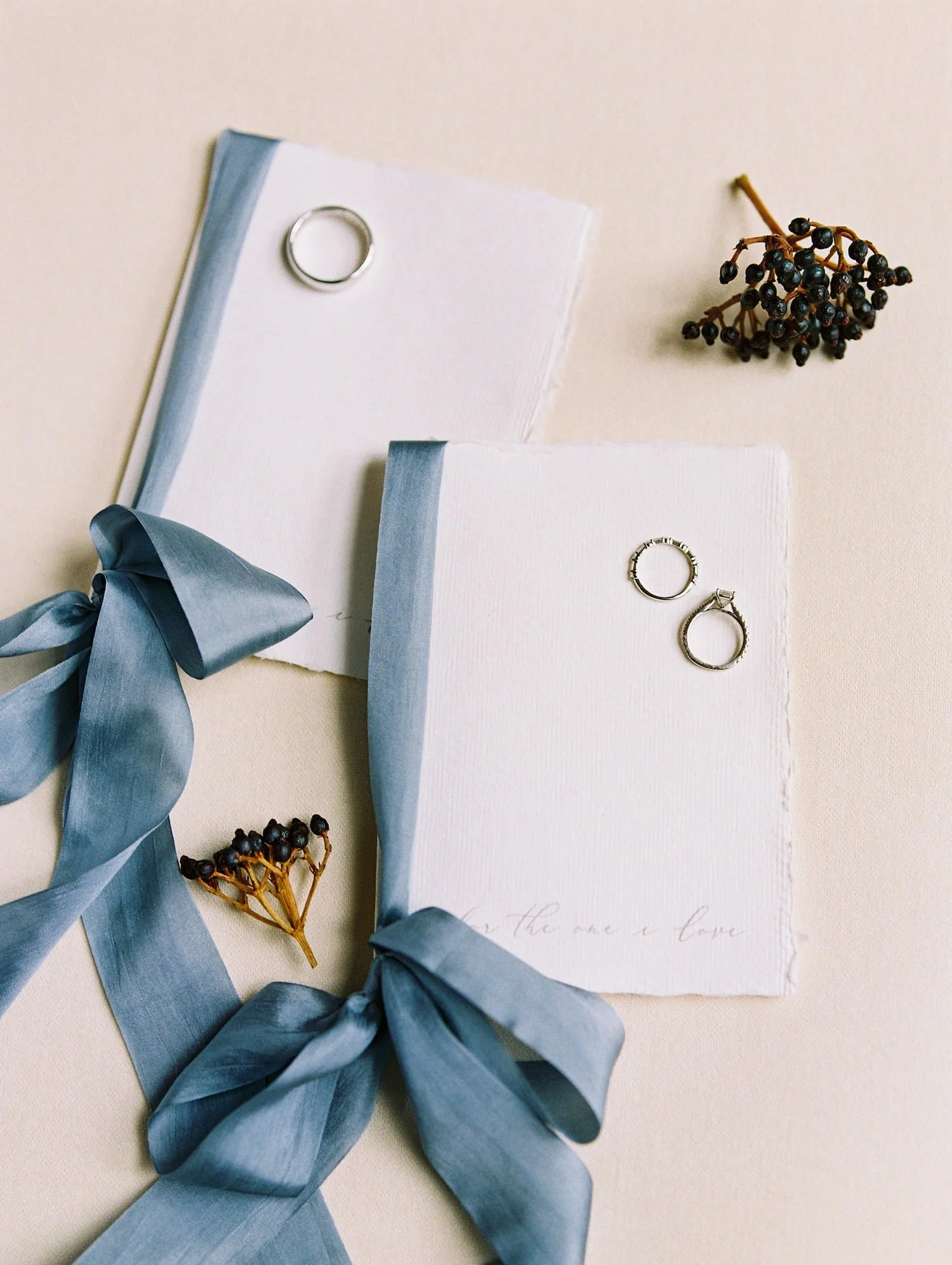 Handmade wedding vow books finished with silk ribbon, created as keepsakes for a winter wedding at the St. Regis Aspen.