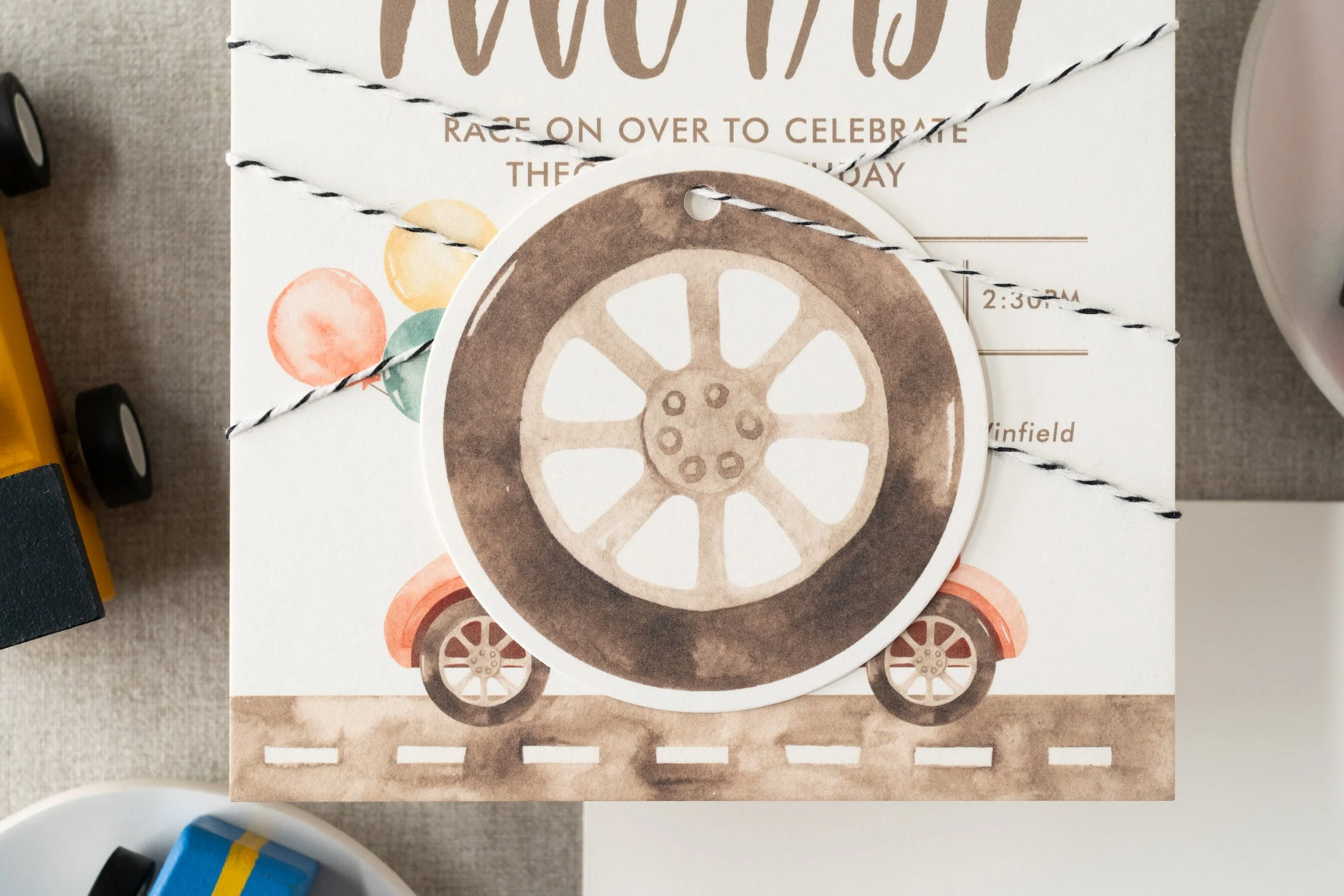 Race car-themed second birthday stationery suite with playful watercolor cars, checkered flag patterns, and motorsport-inspired paper details.