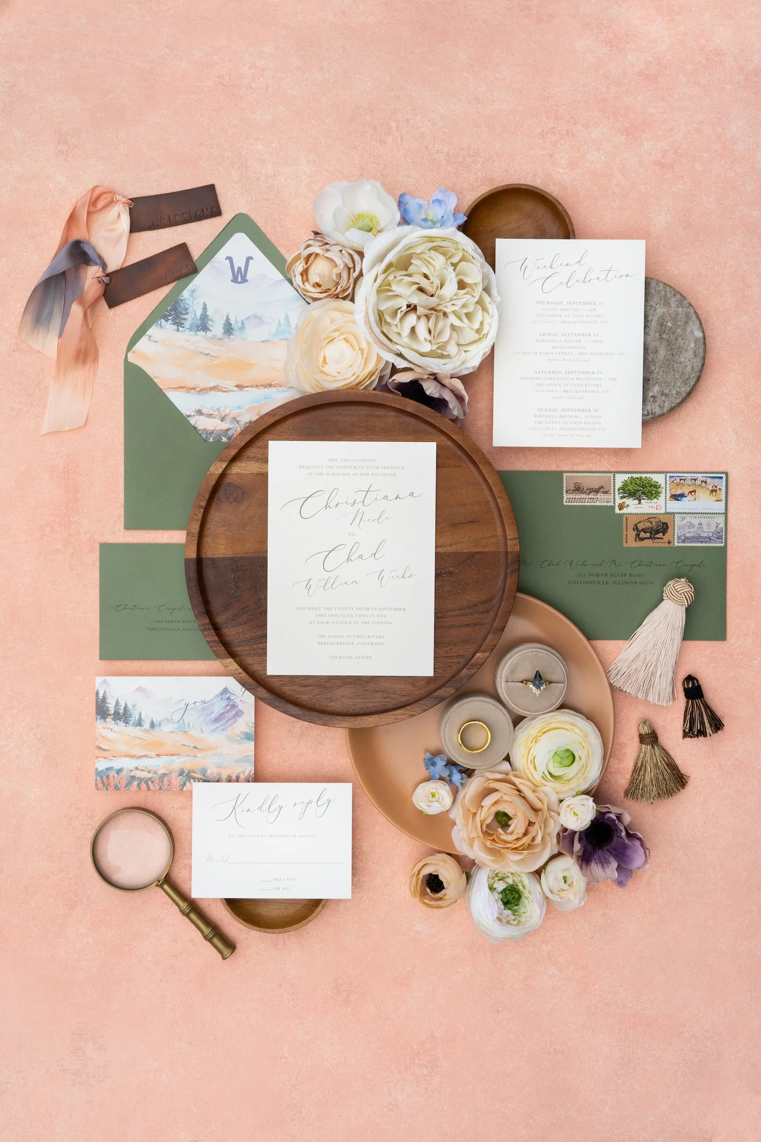 Luxury mountain ranch wedding invitation suite featuring watercolor autumn mountain landscapes, peach and sage color palette, modern script typography, handmade paper, and Western-inspired details arranged in an elegant flat lay.