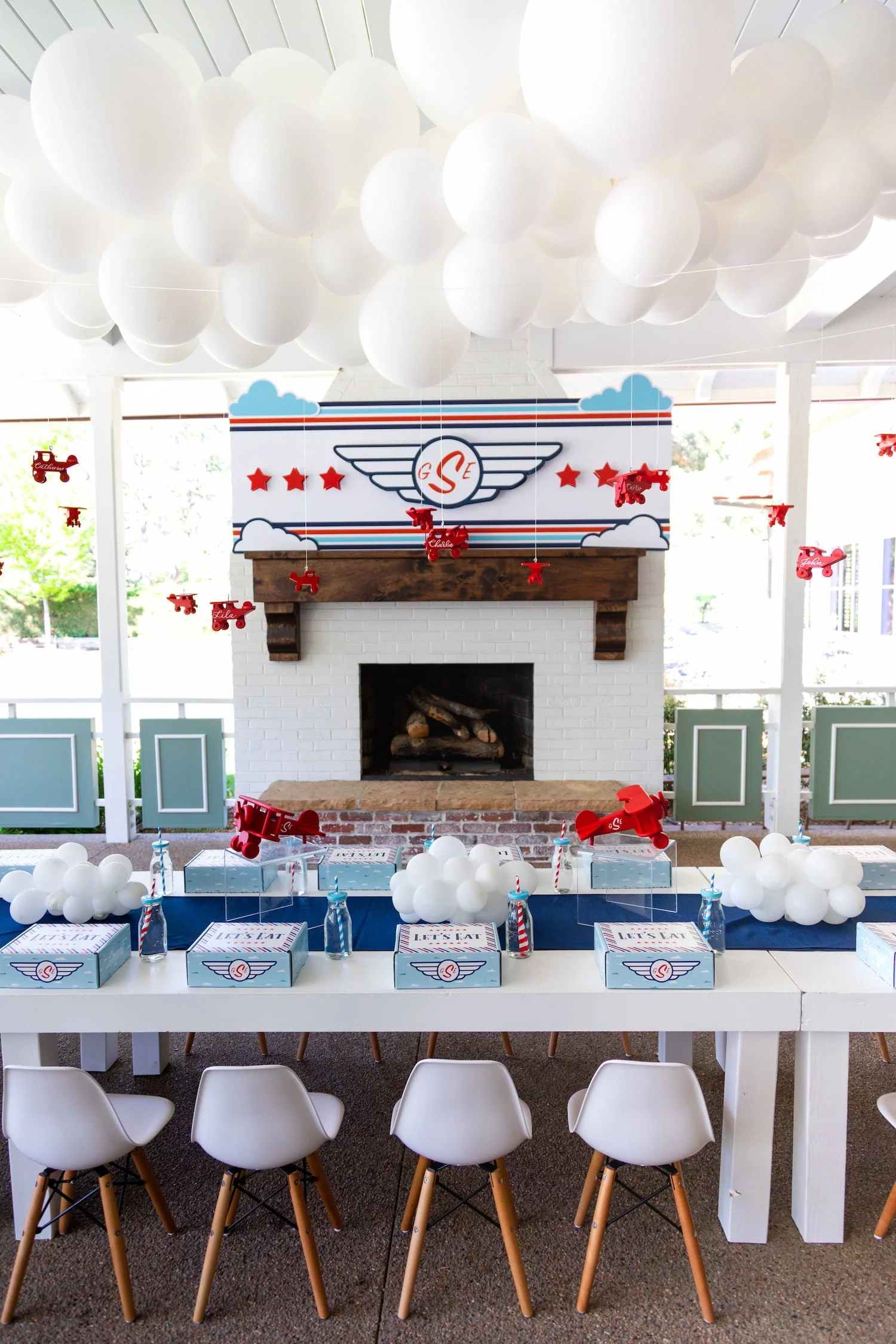 Airplane birthday party setup with classic red, white, and blue color palette, pilot-inspired details, and whimsical aviation decor for young children.