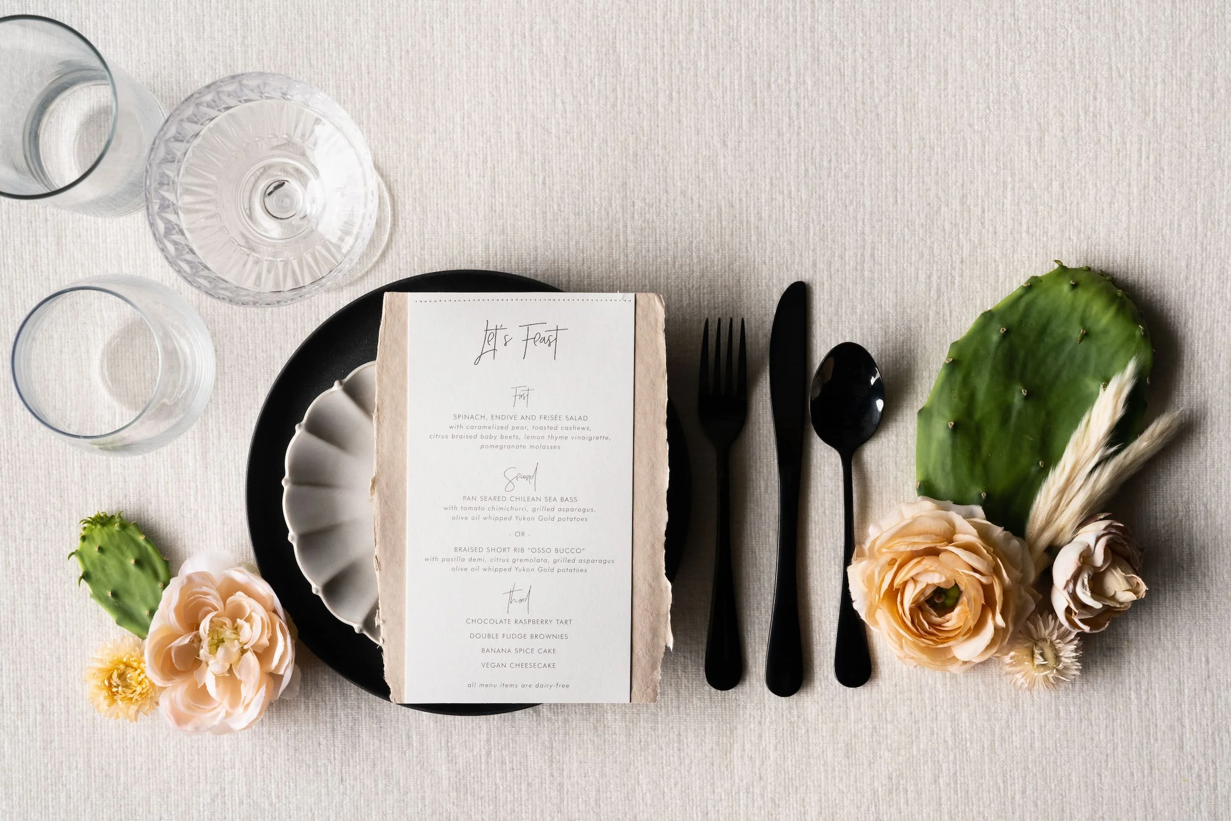 Luxury handmade paper wedding suite and menu with letterpress printing and sophisticated desert textures designed for an upscale Scottsdale wedding celebration.