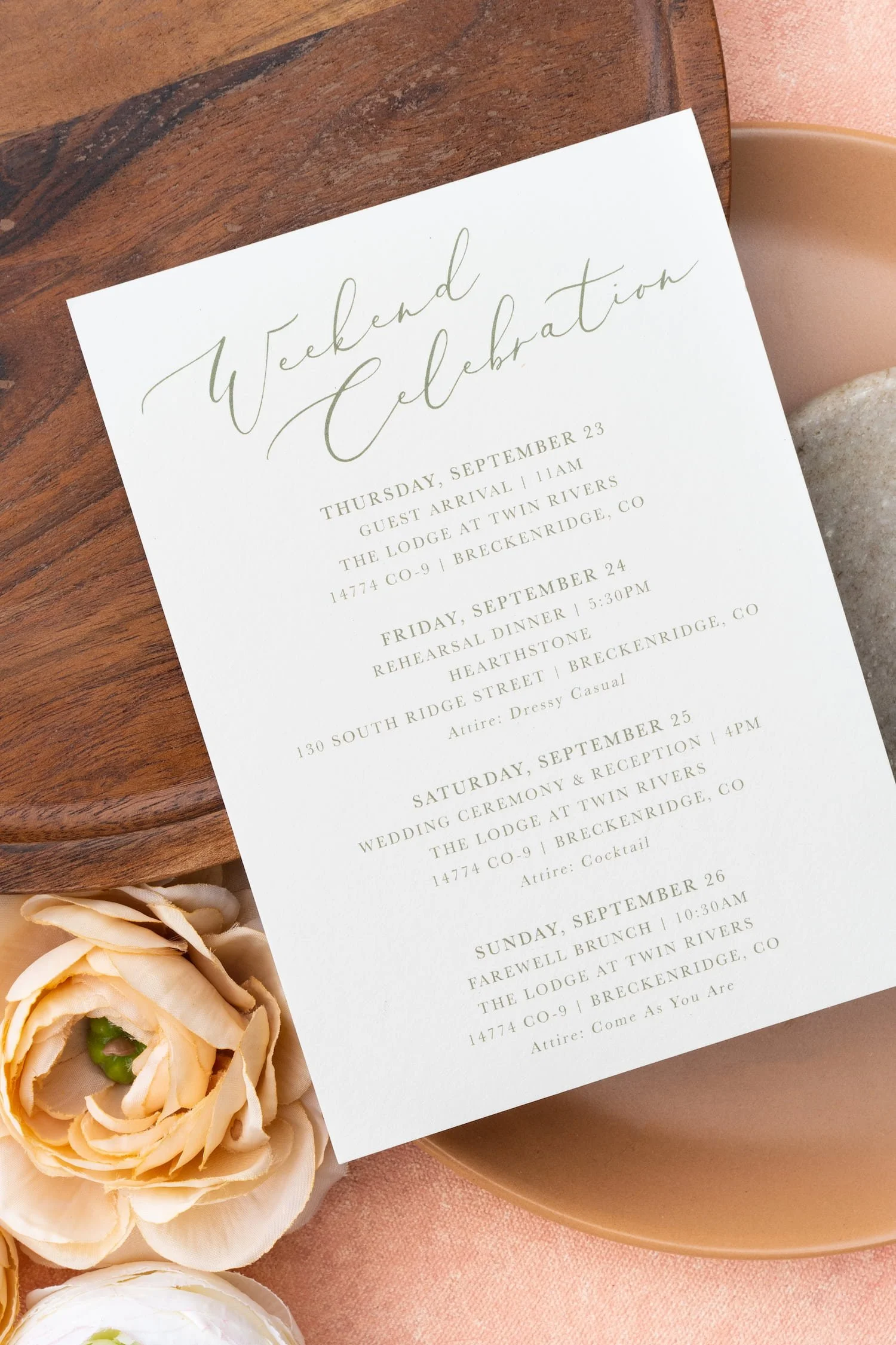 Luxury mountain ranch wedding invitation suite featuring watercolor autumn mountain landscapes, peach and sage color palette, modern script typography, handmade paper, and Western-inspired details arranged in an elegant flat lay.
