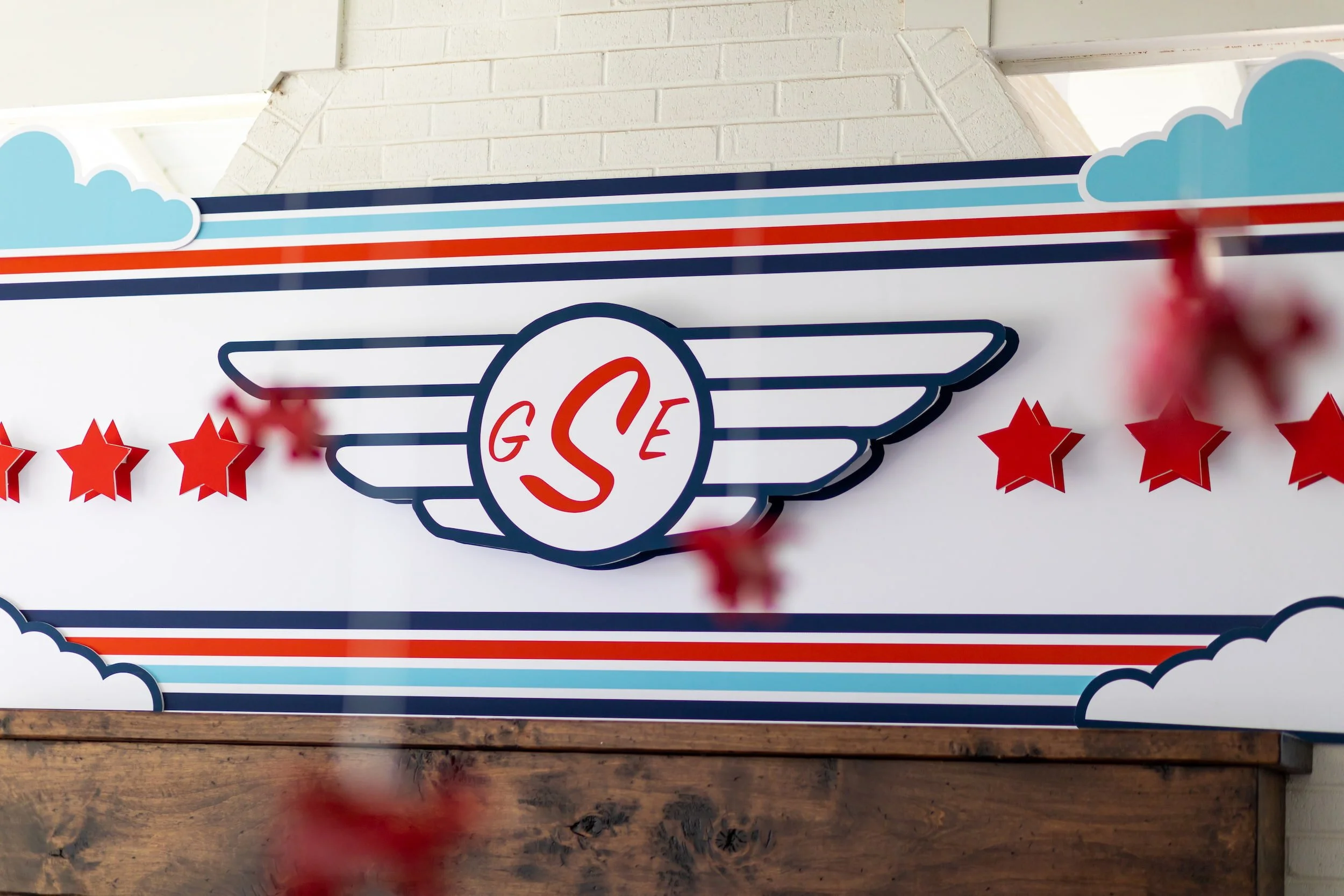 Red, white, and blue airplane birthday party featuring aviation-themed decor, custom signage, and playful details for a two- and four-year-old celebration.