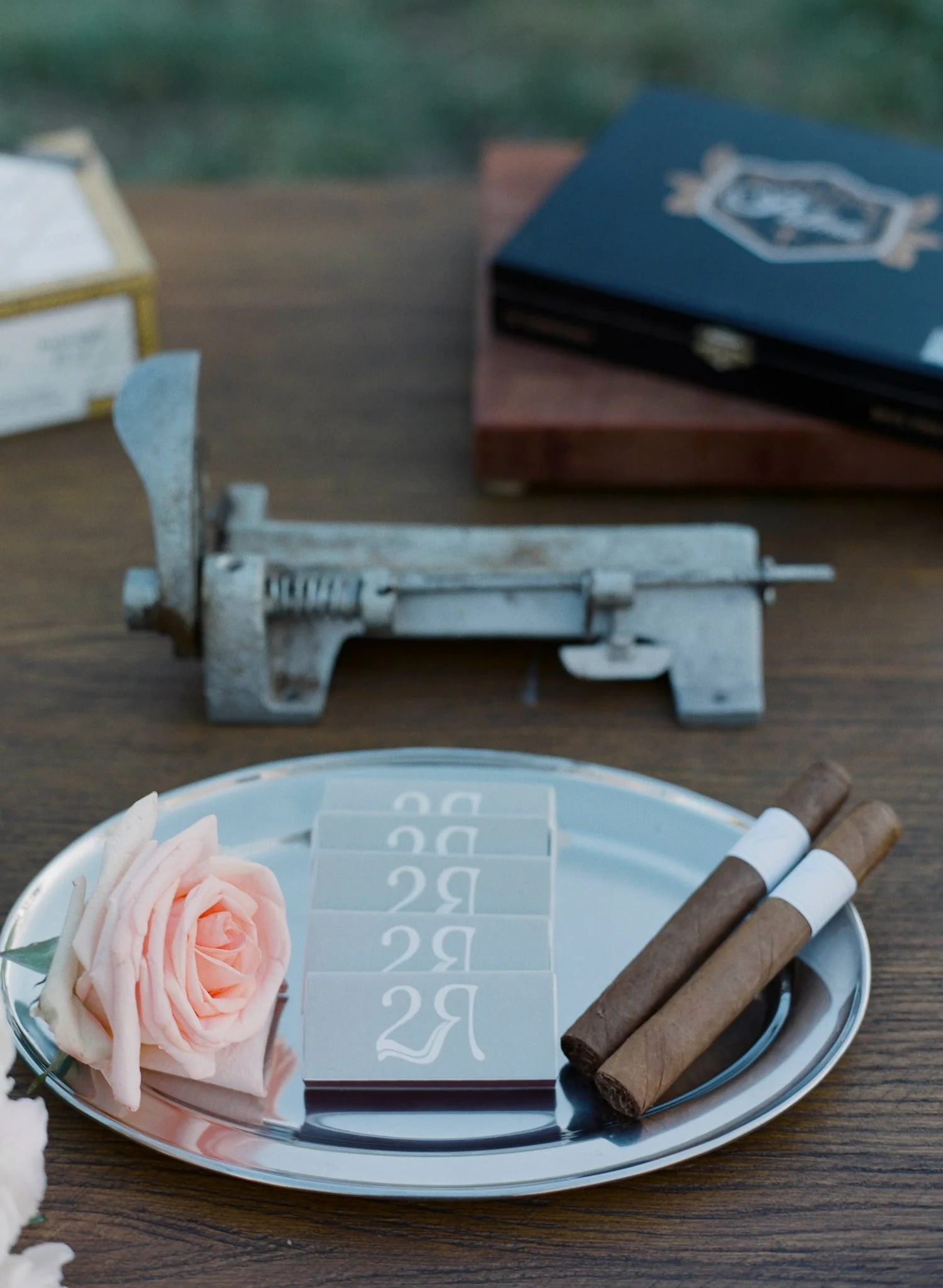 Coordinated wedding day stationery including custom cigar matches for the cigar bar, ceremony programs, acrylic seating chart, signature cocktail signs, menus, place cards, and table numbers for an elegant fall wedding in Steamboat Springs.