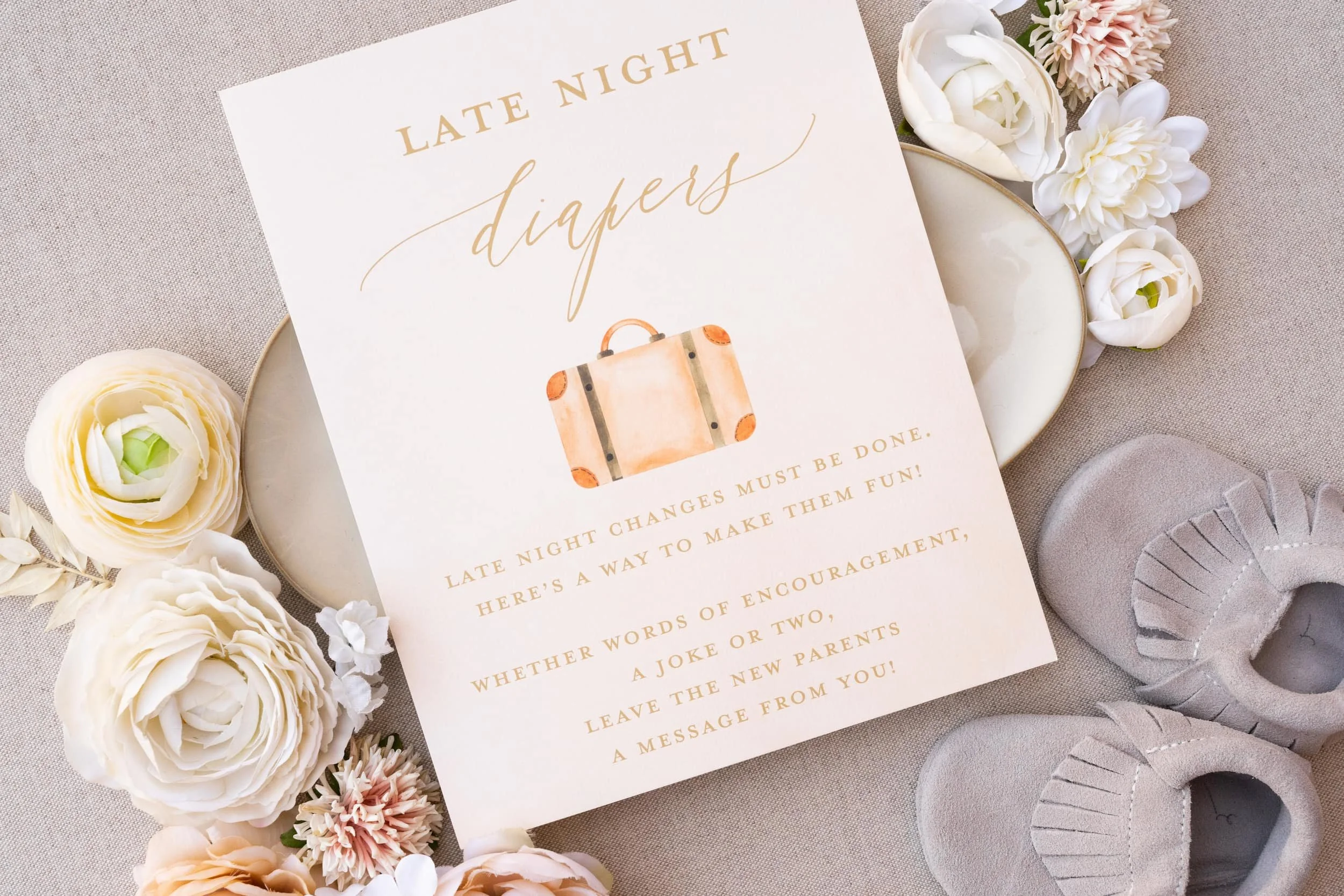 Adventure-themed baby shower games card with warm peach and sage watercolor illustrations and modern typography featuring fun activities for guests during the celebration.