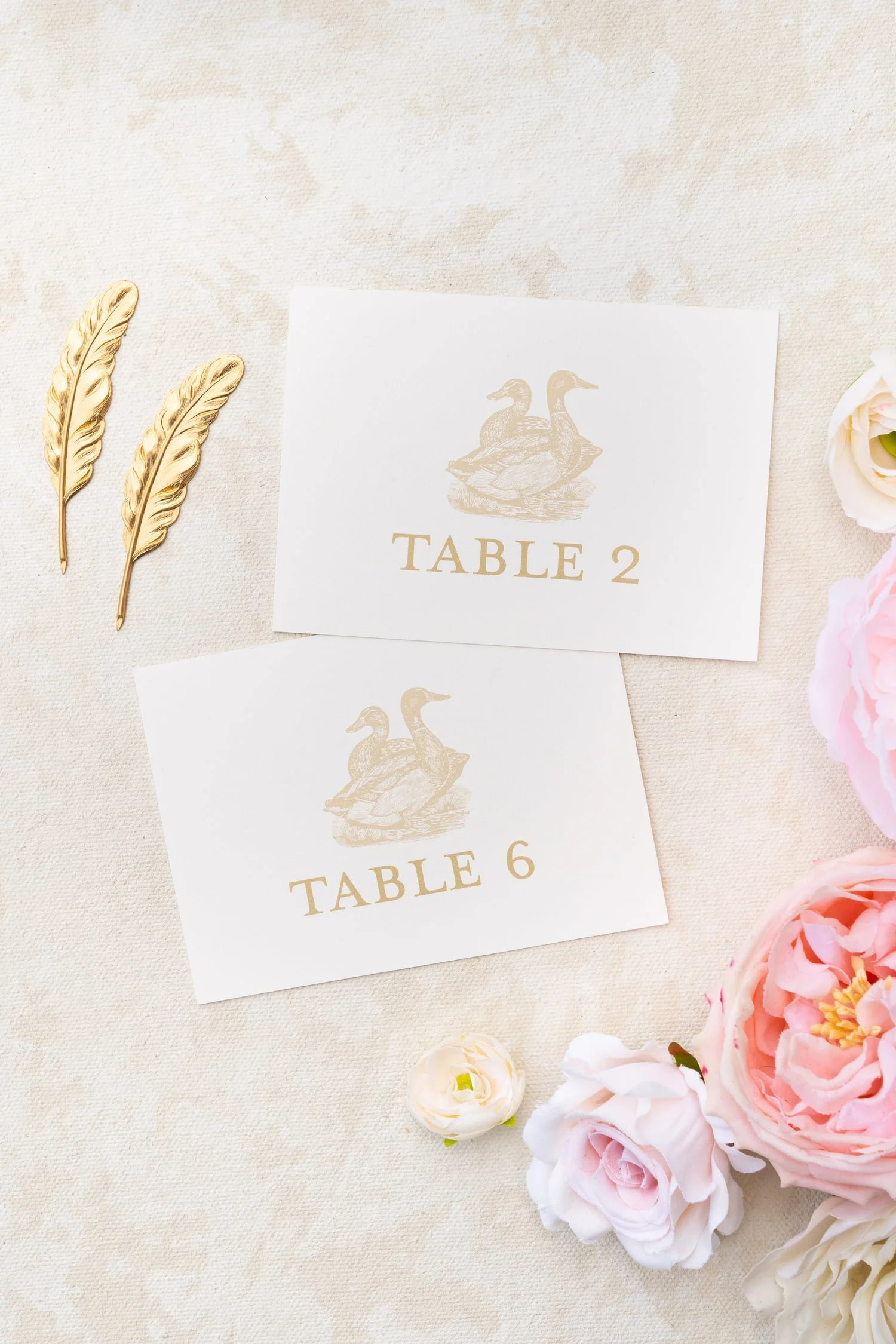 Luxury wedding stationery suite and table numbers in blush, ivory, and gold with delicate lace accents, hand-sewn embellishments, and romantic details created for a Chicago celebration blending Korean and American heritage.