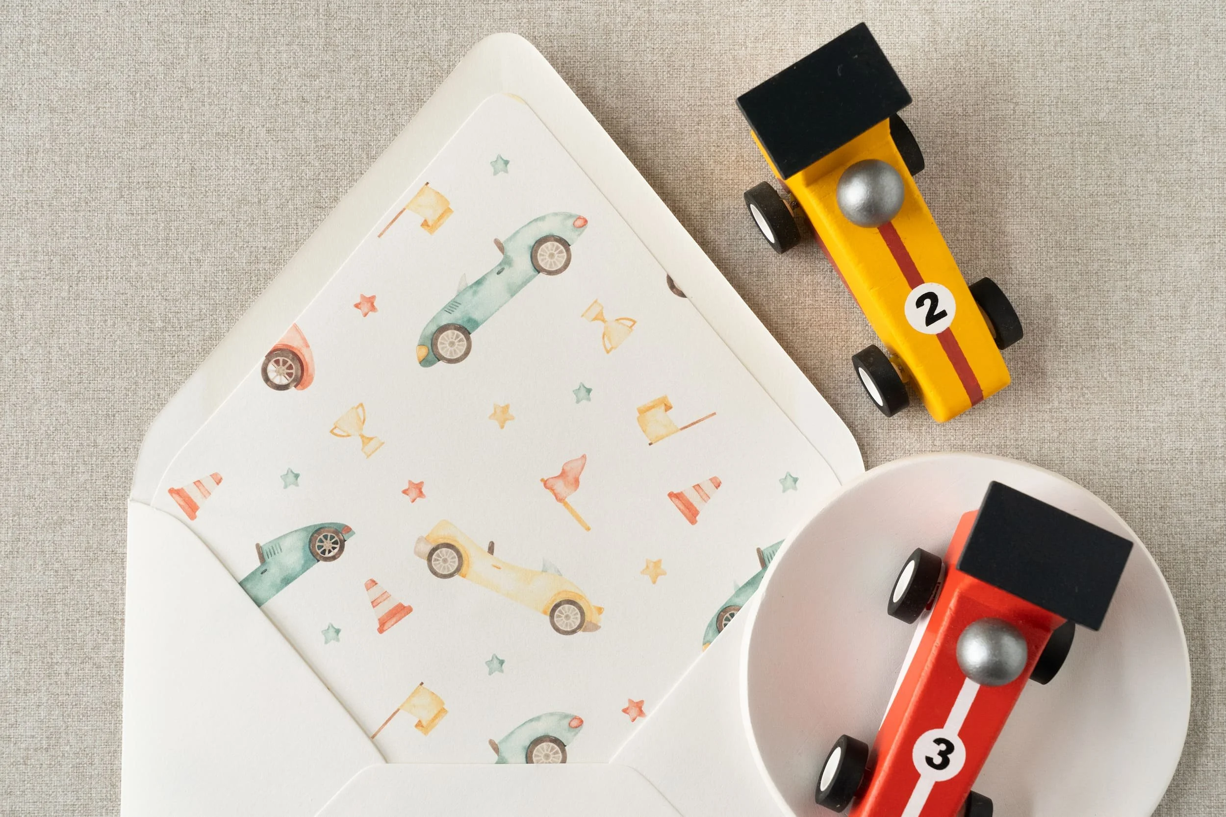 “Two Fast” race car birthday invitation suite for a two-year-old boy featuring watercolor race car illustrations, black-and-white check details, and vintage-inspired racing stamps.