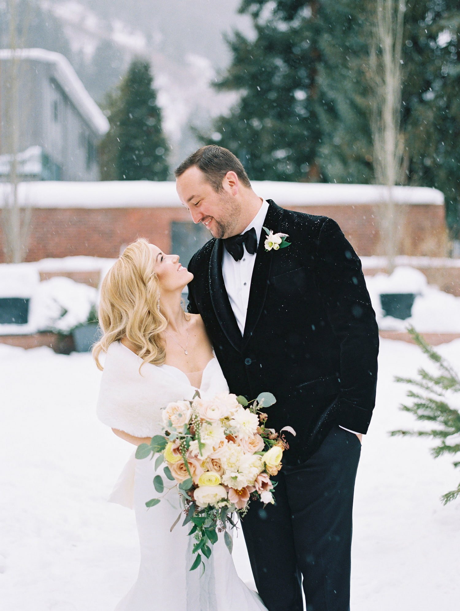 Bride and groom at winter wedding at St. Regis Aspen in Aspen, Colorado.