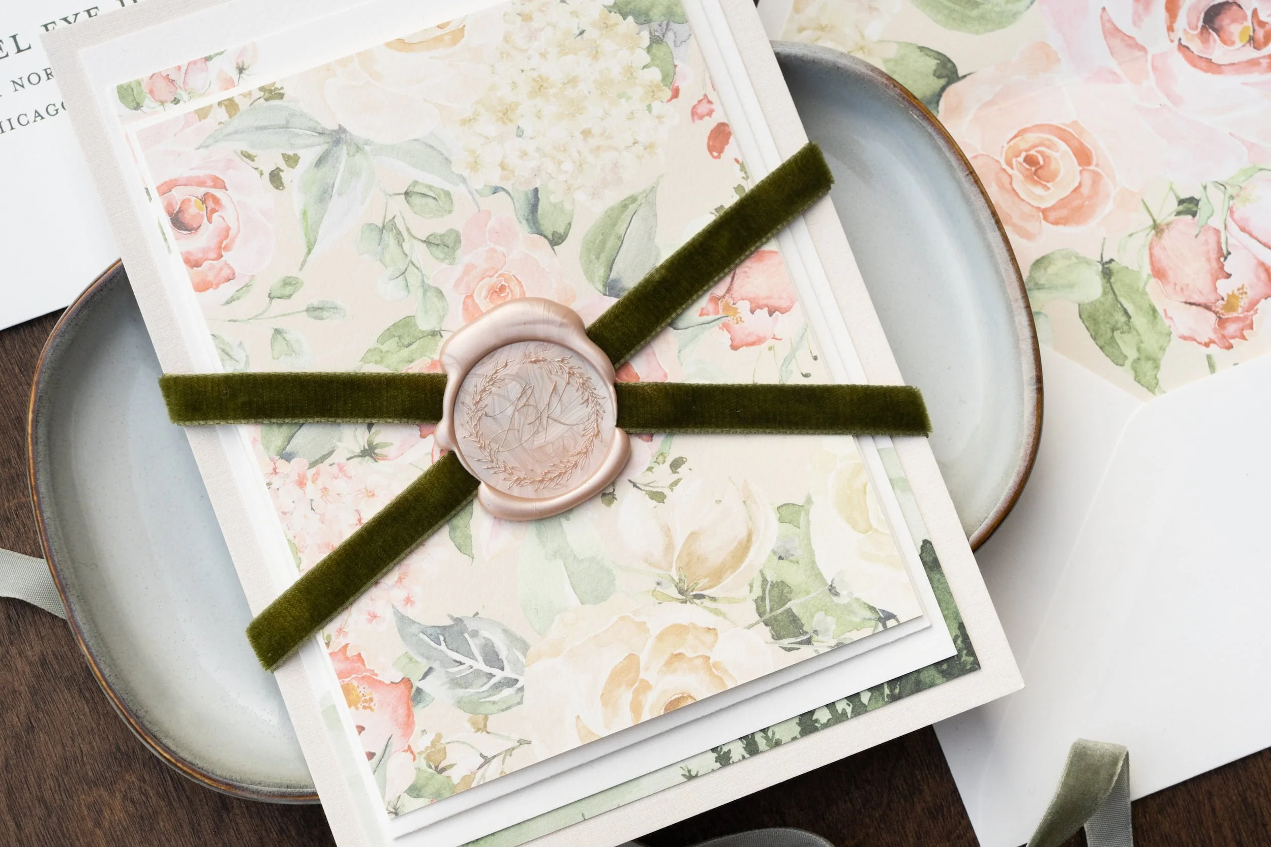Elegant destination wedding invitation suite featuring watercolor mountain artwork, blush and white flowers, textured paper details, and luxury finishing touches inspired by Aspen, Colorado.