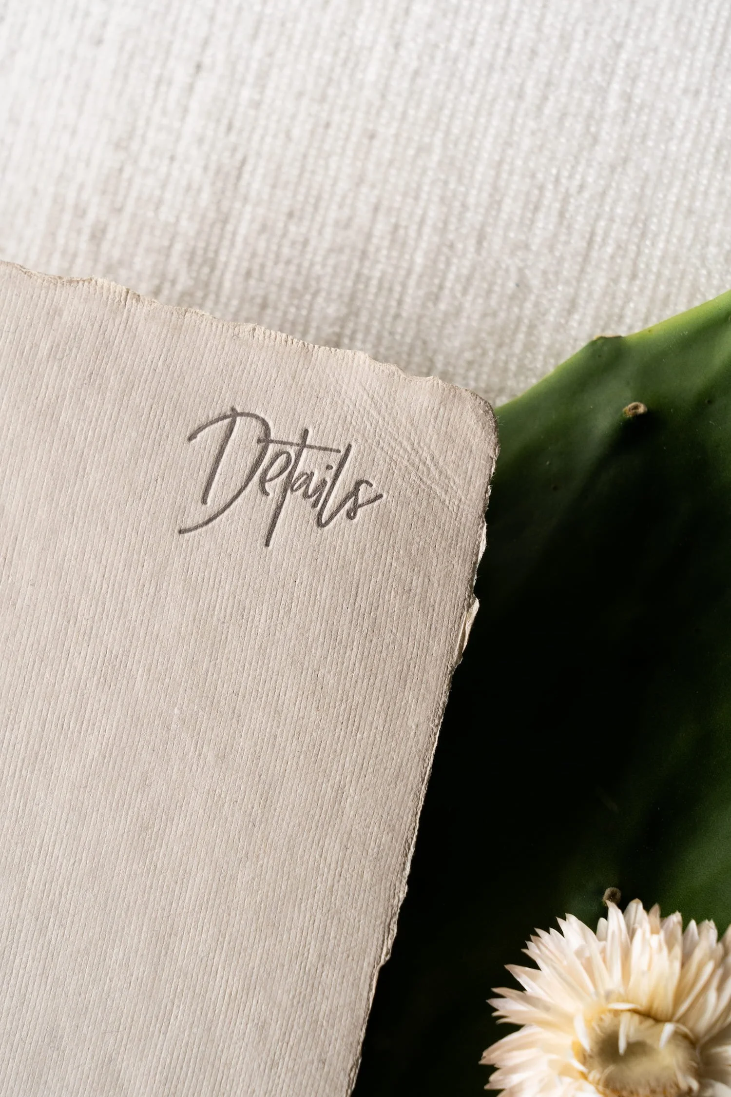 Elegant Scottsdale wedding invitation suite featuring handmade paper, letterpress printing, and refined desert-inspired details for a luxury Four Seasons wedding.