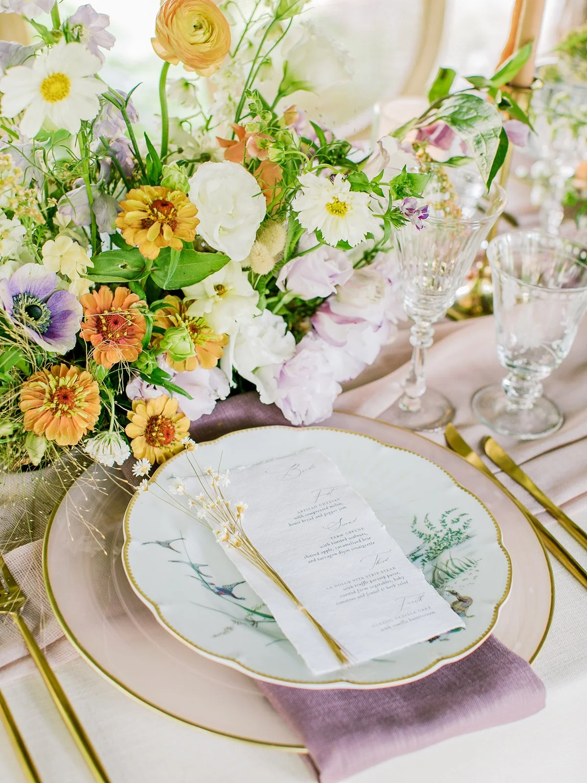 Handmade paper wedding menus wrapped in plant-dyed silk, reflecting the natural textures and wildflower-inspired colors of a Boulder Flower Farm wedding.