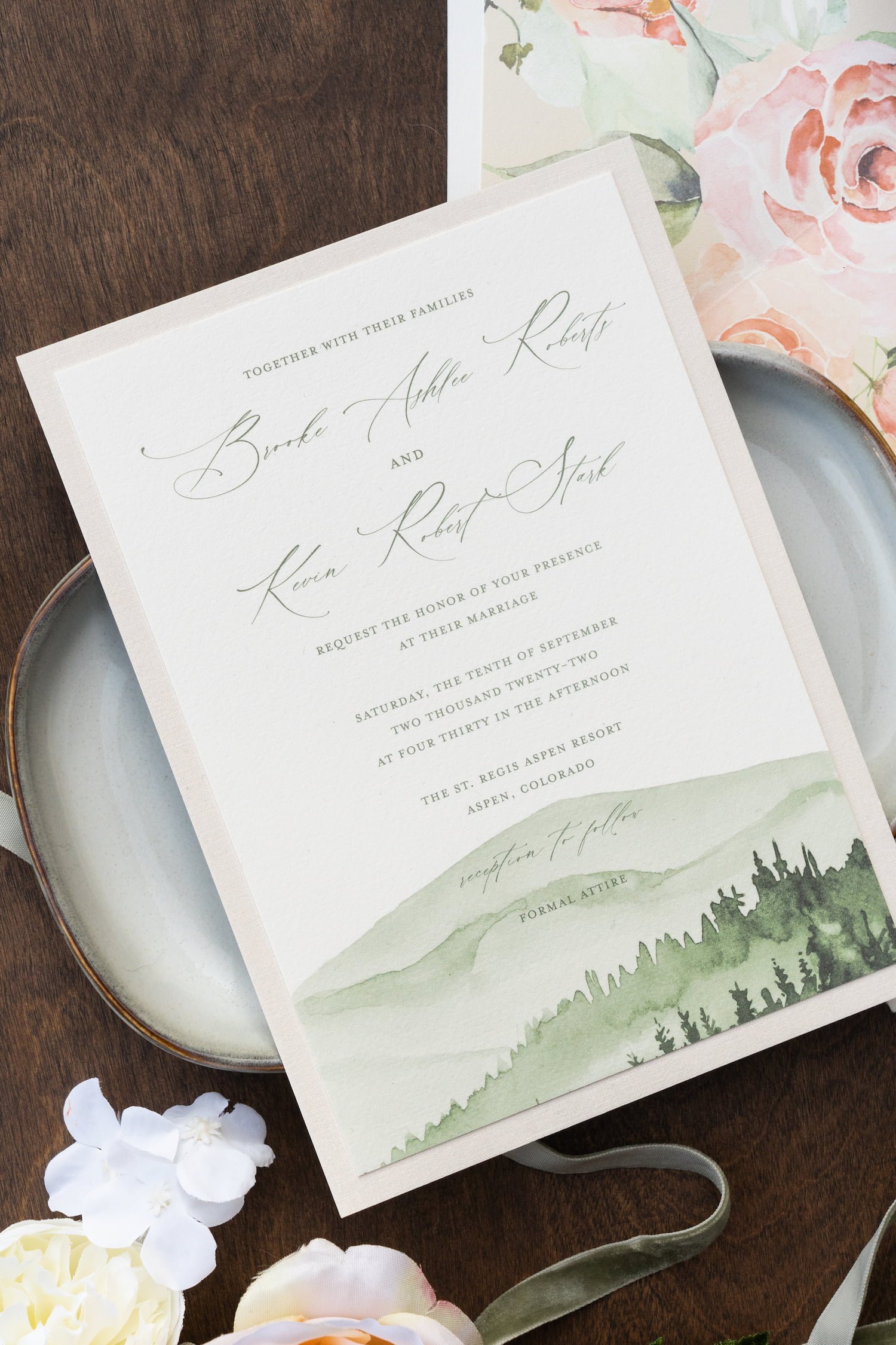 Elegant destination wedding invitation suite featuring watercolor mountain artwork, blush and white flowers, textured paper details, and luxury finishing touches inspired by Aspen, Colorado.