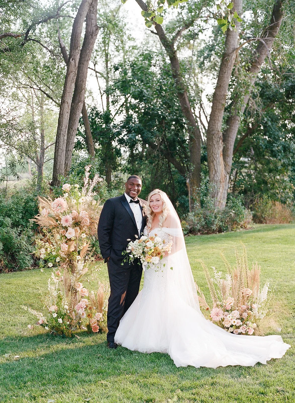 Bride and groom at Boulder Flower Farm with wildflowers in the background.