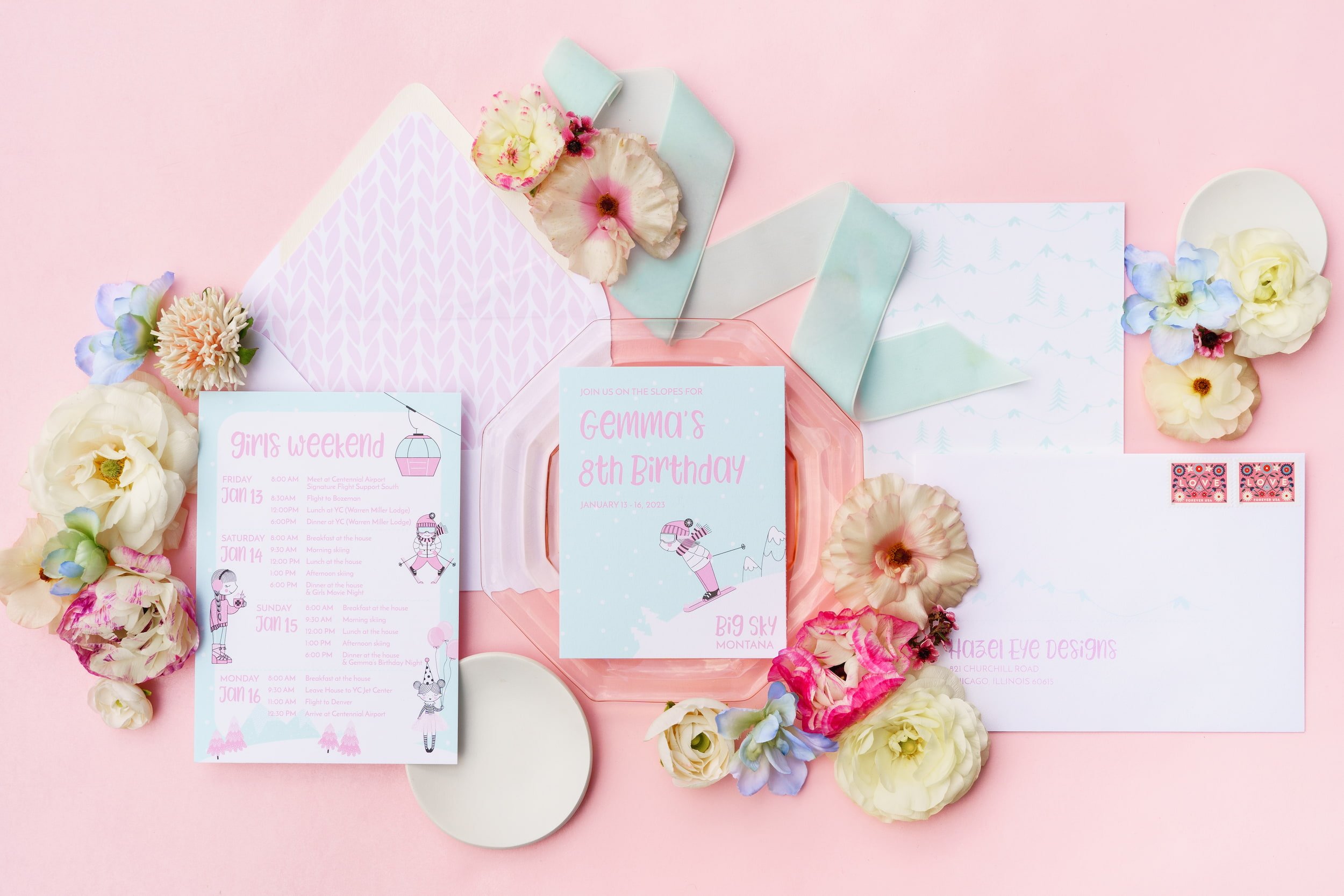 Luxury ski-themed birthday invitation suite for an eight-year-old girl featuring pink and aqua details, fluffy tulle ribbon, ski motifs, cable-knit envelope liners, and alpine-inspired postage.