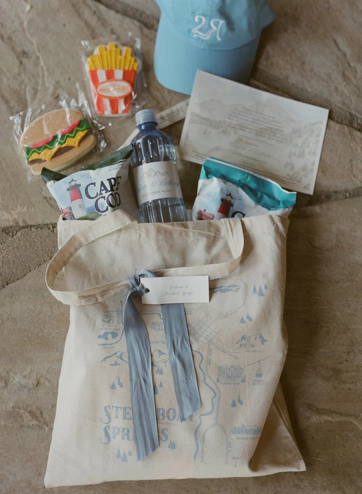 Wedding welcome bag featuring curated gifts, custom stationery, and Whataburger cookies flown in from Texas as a personal surprise from the couple.