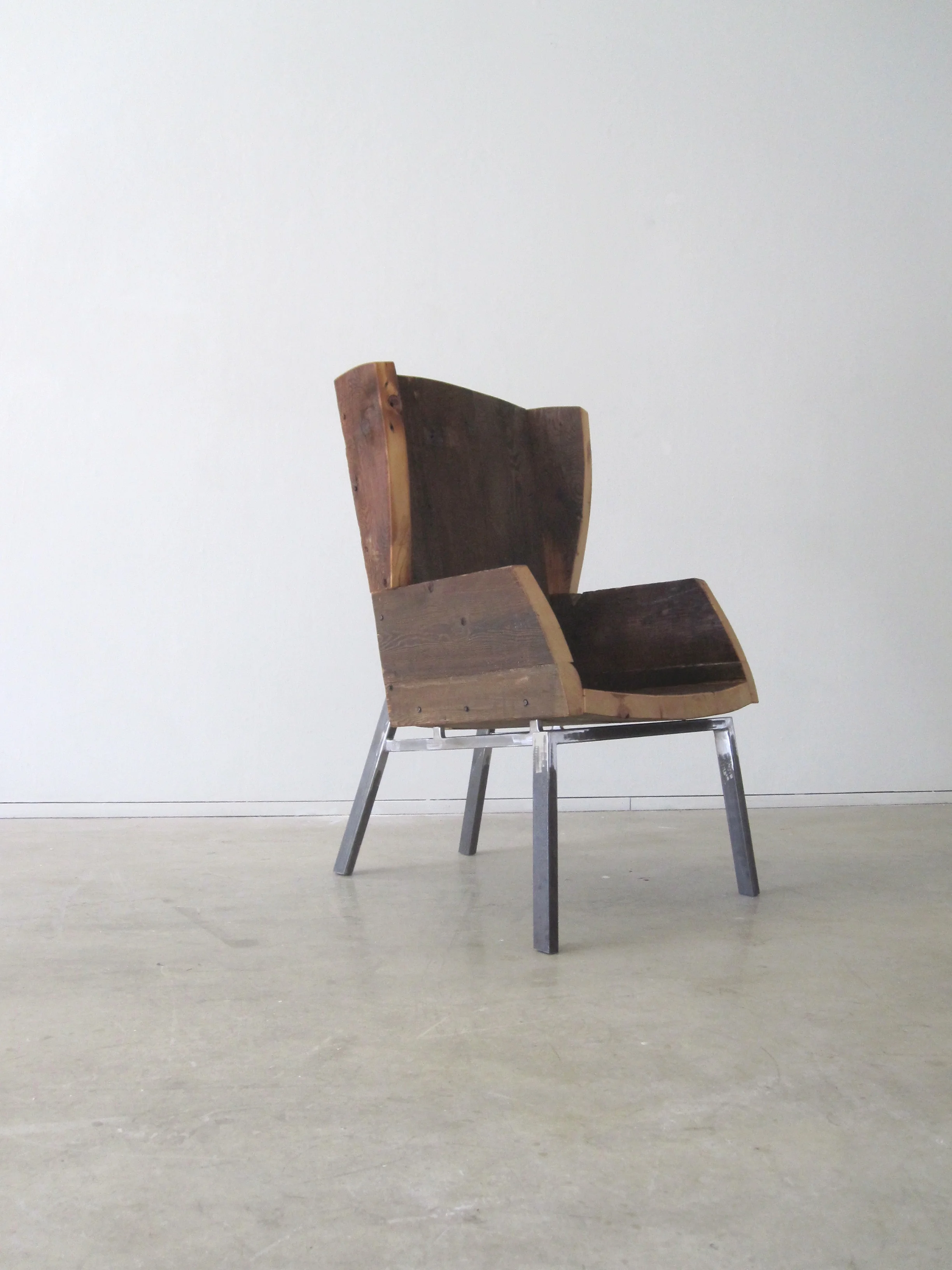  The Wingback Chair is designed for material efficency and maximum comfort. Made by hand, salvaged wood defines each unique piece. While initially visually arresting, one can sit in this chair for hours. 