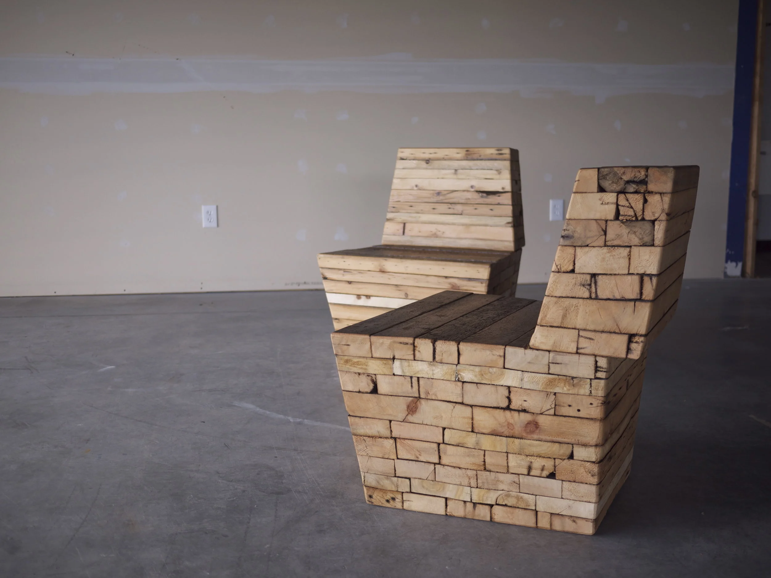  Within each Monolith lies a proposal: what to do with lumber from homes demolished and destined for the landfill. Weighing hundreds of pounds, each piece of furniture contains a portion of a house or structure. 