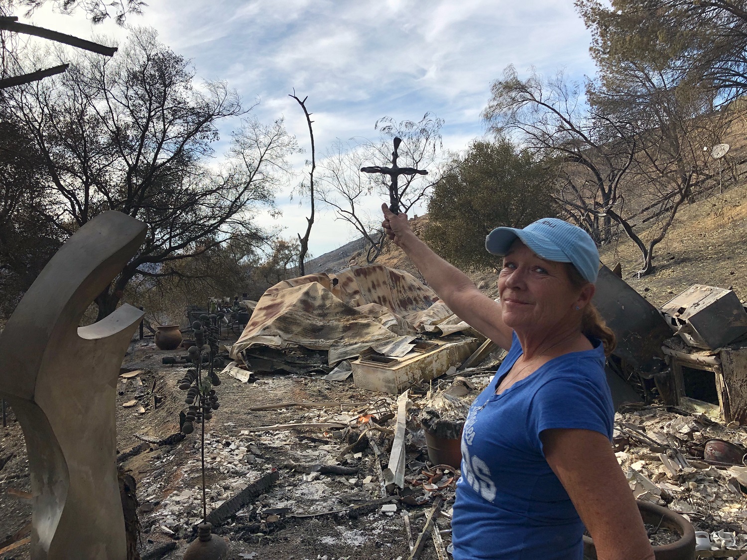 Shannon with cross at rubble.jpeg