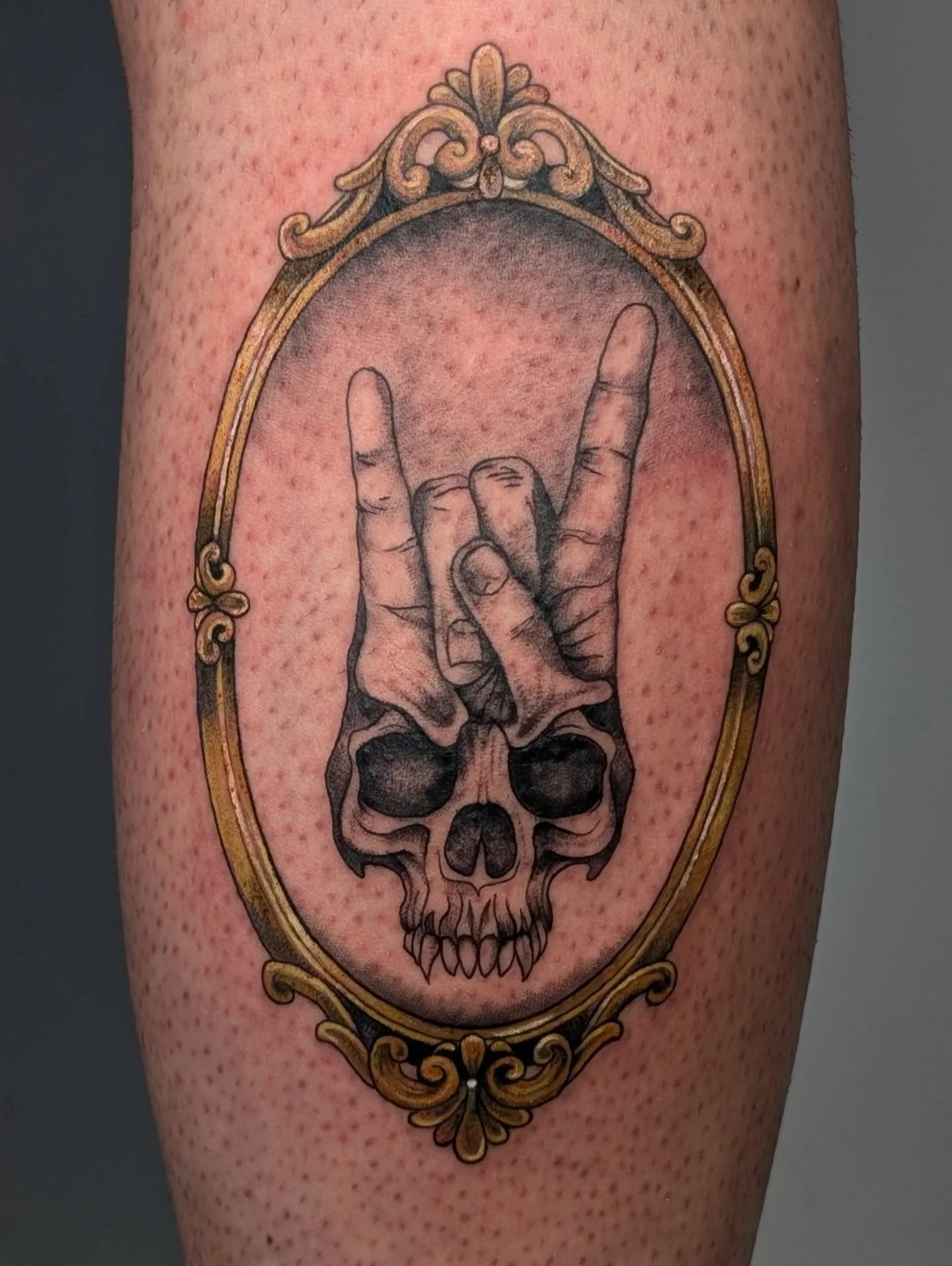 A badass skull tattoo I did for @maitajreacu . I really enjoyed designing and working on this piece. The gold frame is a really cool accent that brings everything together. Swipe to see the healed tattoo and some behind the scenes moments. 
.
#skullt