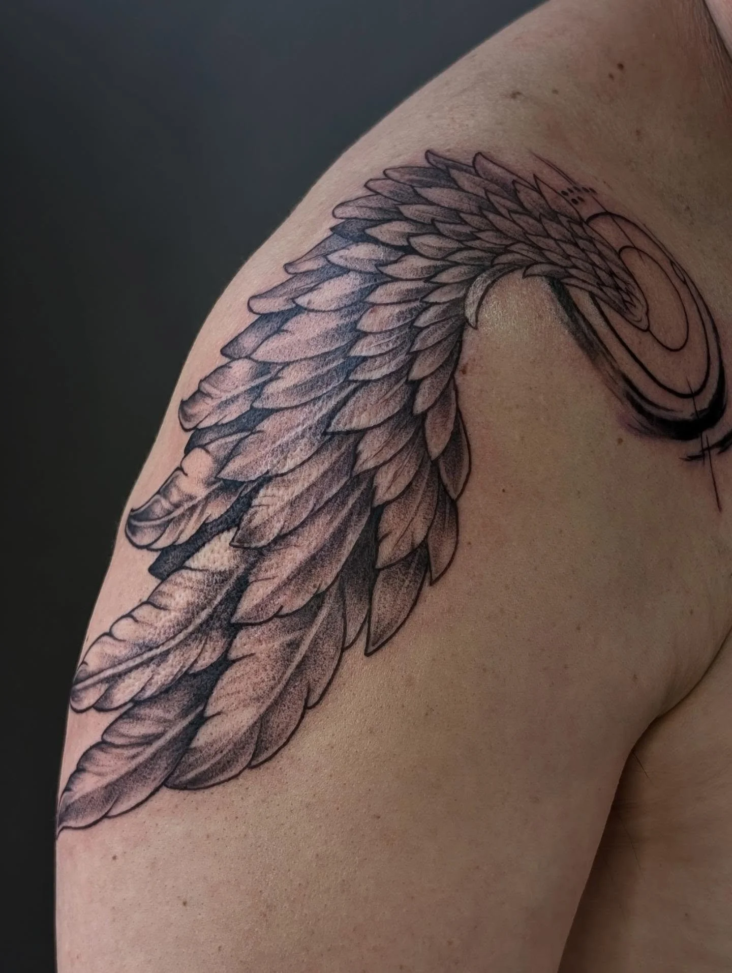 Scar cover-up done a while back. My client had a pretty bad motorcycle accident and wanted to cover up the scar that was left from that accident. We ended up going with this wing design to match what he had on the other shoulder style wise. Swipe to 