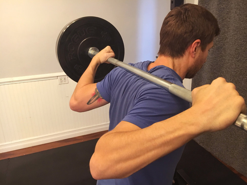 Bar Position: Across shoulders, not on the neck!