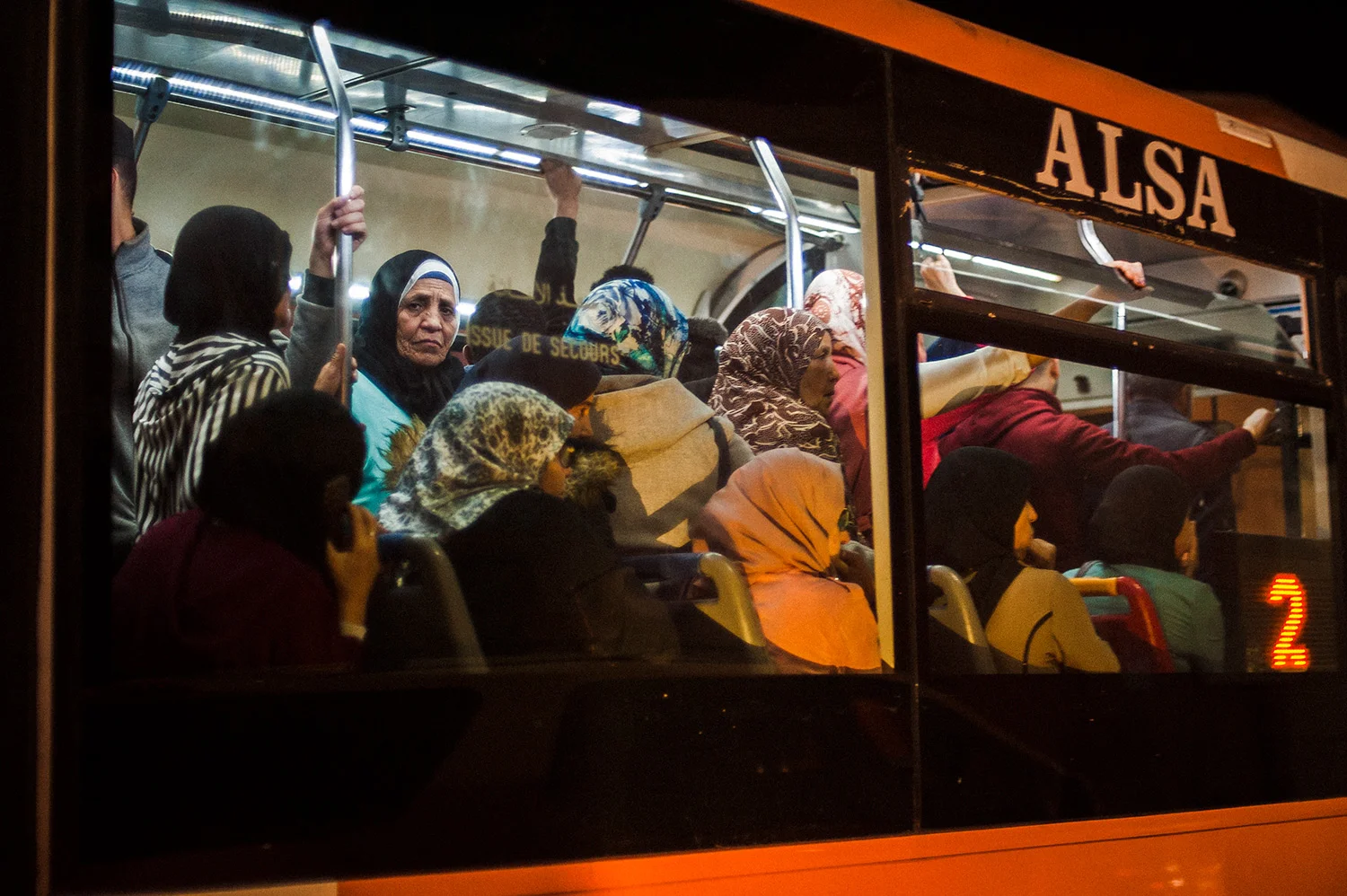 woman on a crowded bus, marrakech, morocco