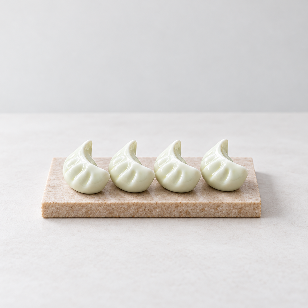 Ceramic+Dumpling+Chopstick+Rests+on+Stone.png