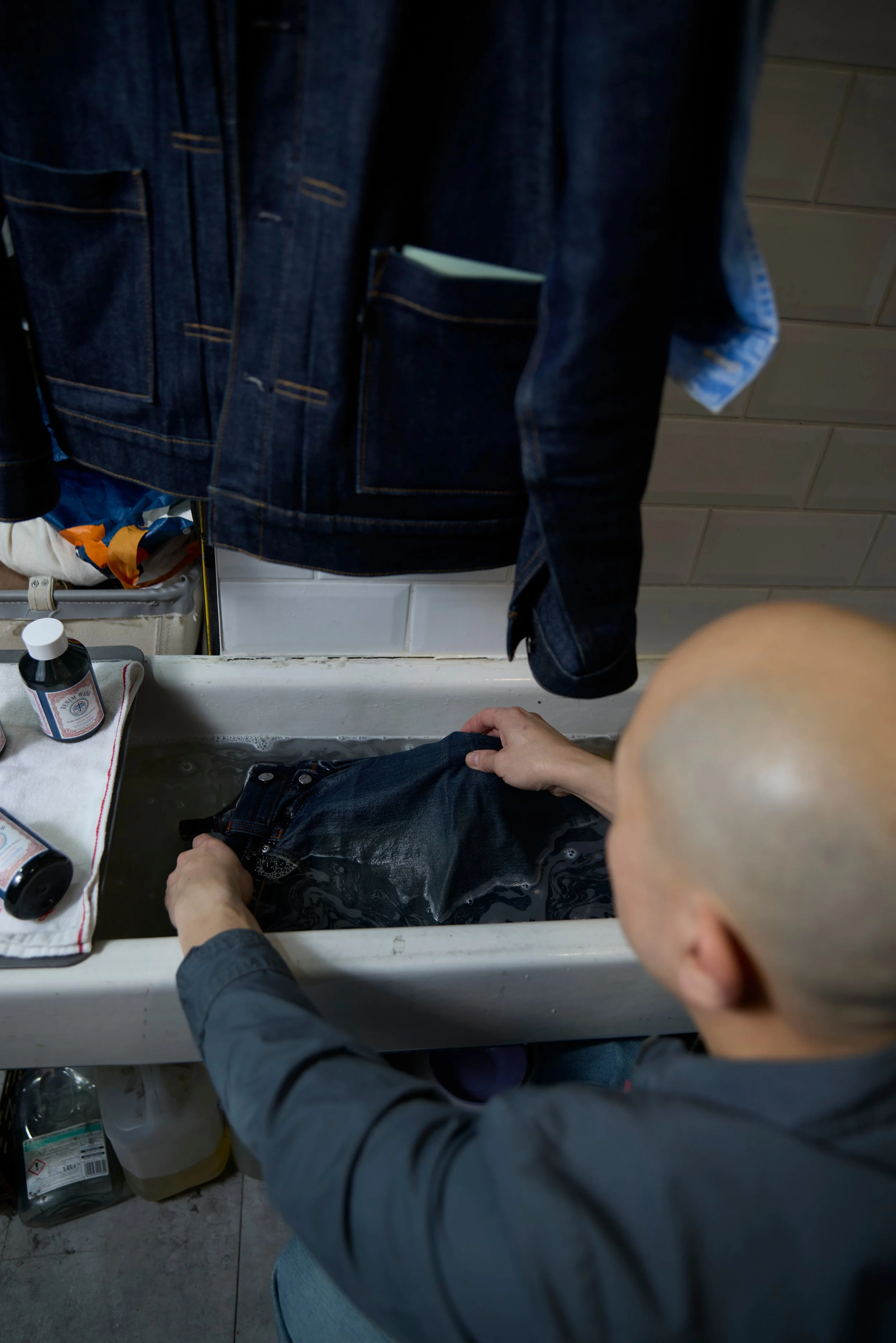 Tony hand-washing a pair of denim jeans at The Steam Room in Haggerston