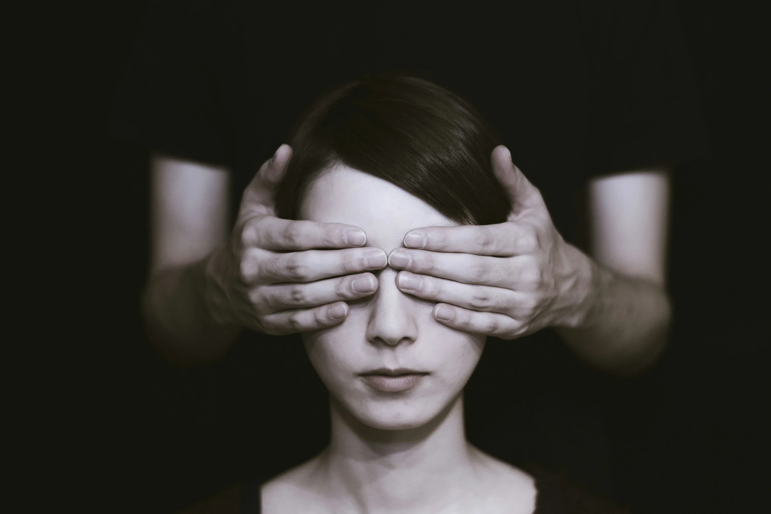 Hands covering woman's eyes to represent Love is Blind, not being able to see your potential partner.