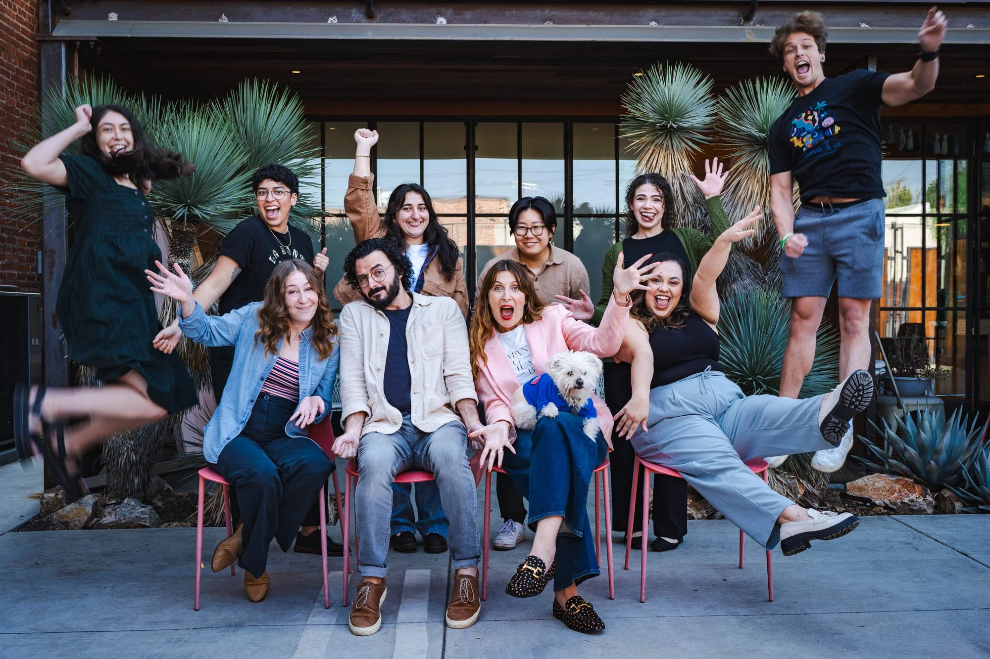 Kindman & Co. team playfully jumping at therapy office in Highland Park