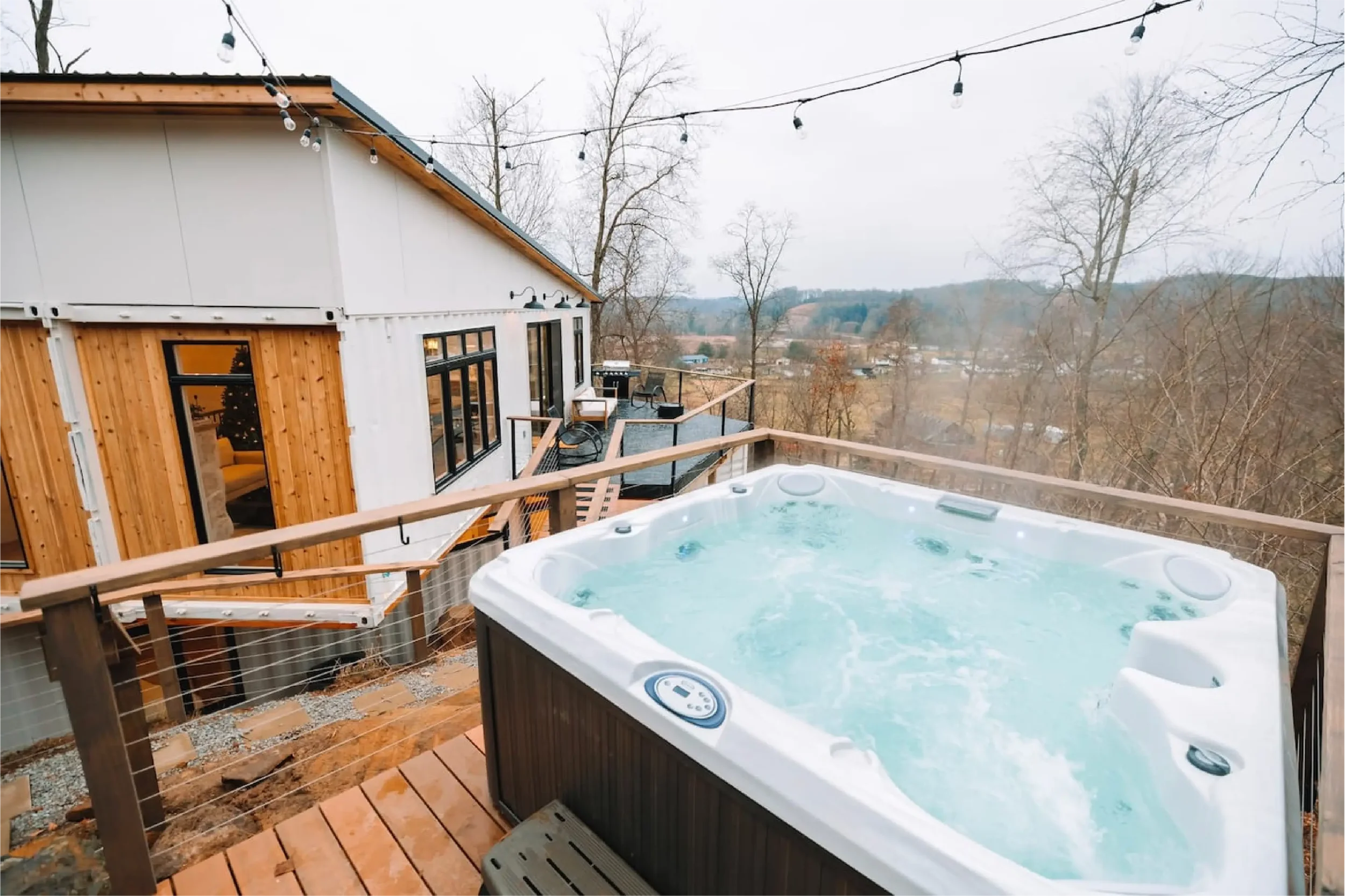 Hot tub on a cliffside deck overlooking the Hocking Hills valley at The Overlook cabin