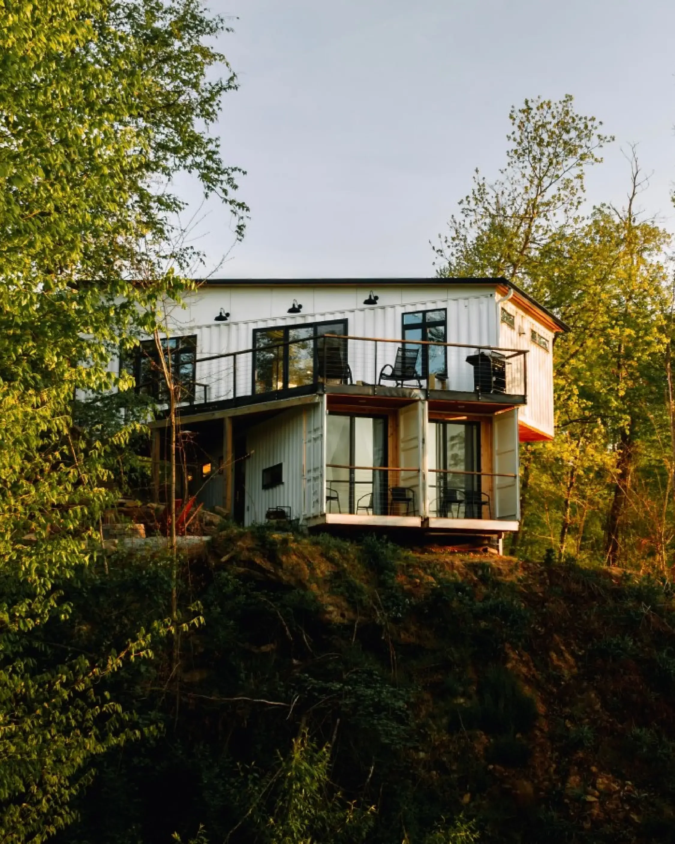Exterior of The Overlook cabin perched on a wooded hillside in Hocking Hills, Ohio, at golden hour