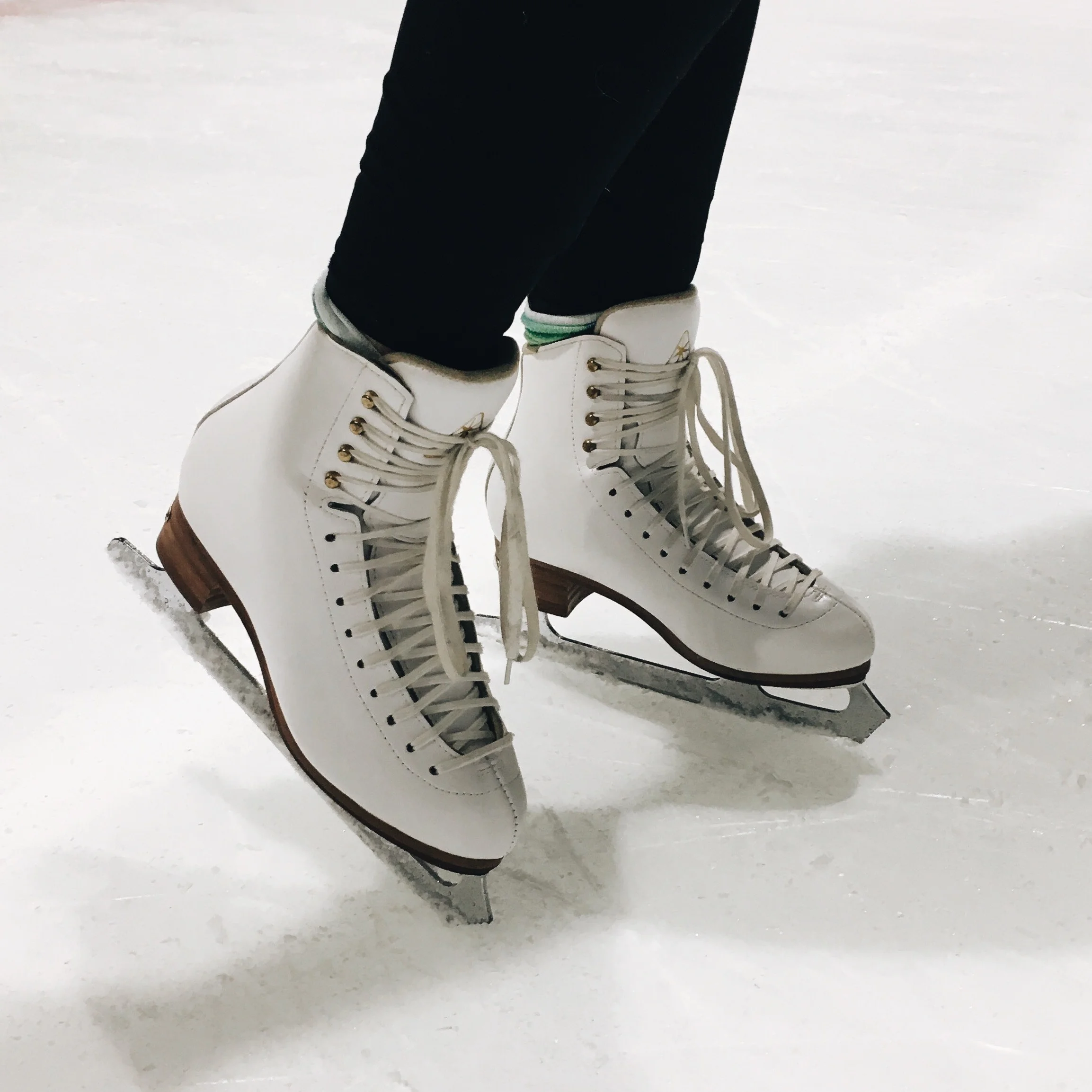 ice skates worn by student at a learn to skate lesson