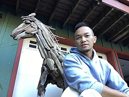 Minh with his first driftwood horse