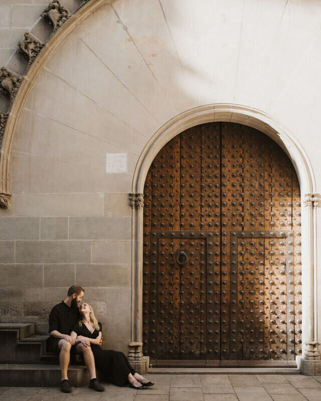 Young sitting old door Gothic architecture