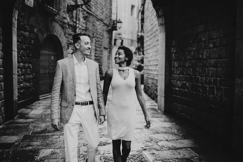 International stylish couple walking black and white Gothic quarter