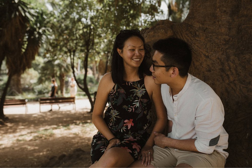 young asian couple under tree