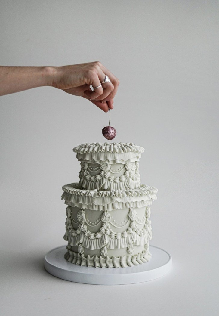 greenish-grey-mini-wedding-cake-with-elaborate-frosting-piping.jpeg