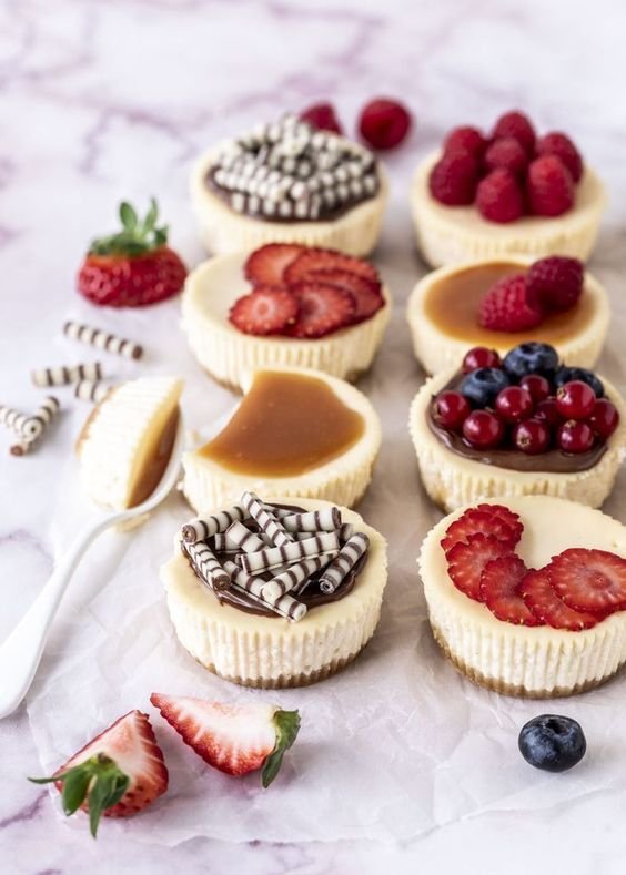 an-assortment-of-mini-cheesecakes-with-fresh-berries-and-berry-slices-salted-caramel-and-mini-chocolate-bites.jpg