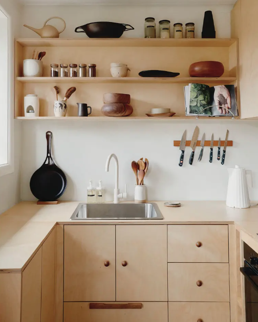    small homes, creative, space, apartment, creative space, tidy, spacious, limited space, open shelving, kitchen, organised, wooden cabinetry, storage, small space, artwork on the walls, artwork, shelves, plants, books, Natural materials, dining roo
