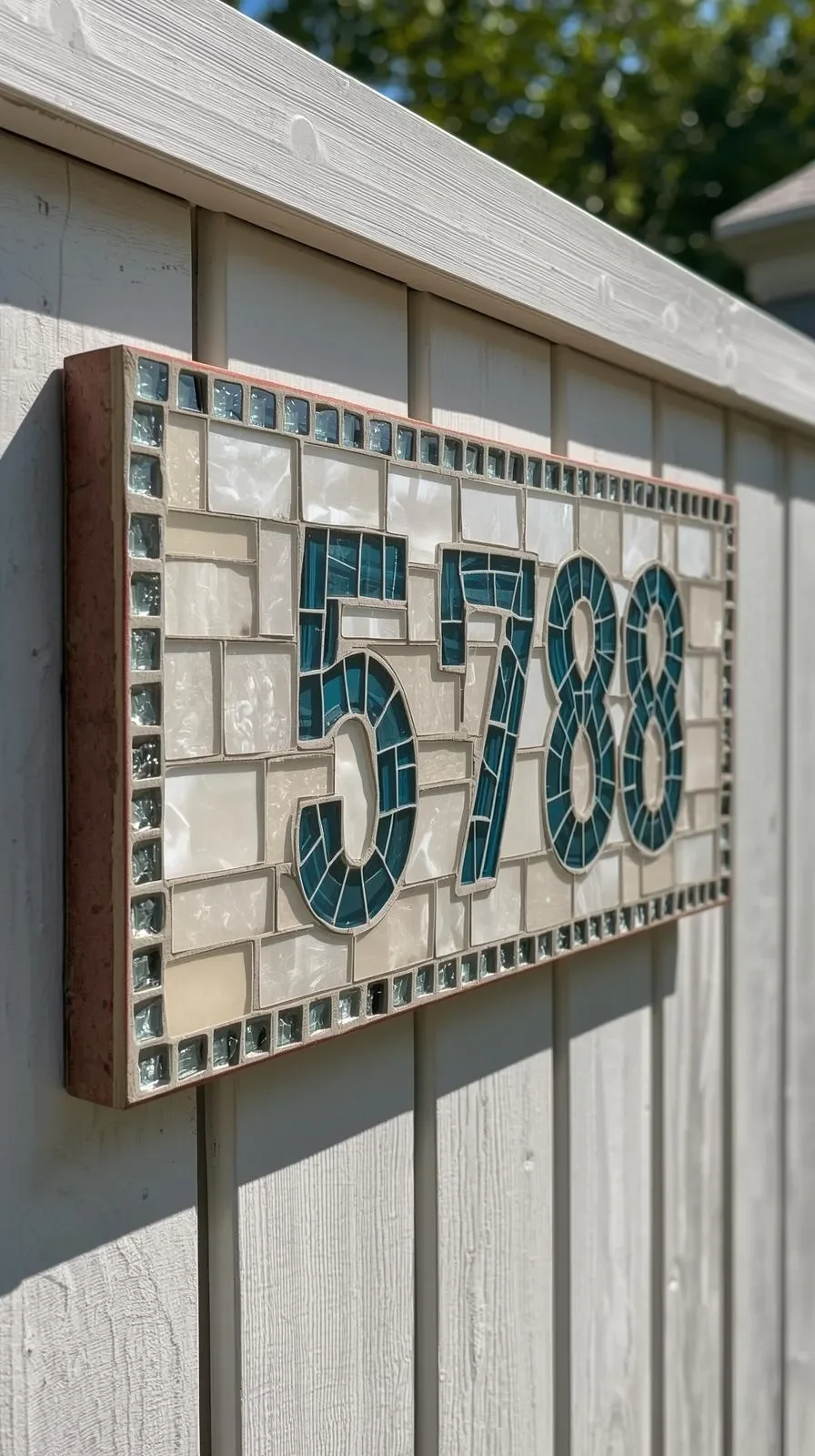 Handmade-mosaic-address-sign-with-glass-tile-numbers-mounted-on-a-neutral-garden-fence-bold-readable-design.jpg.webp