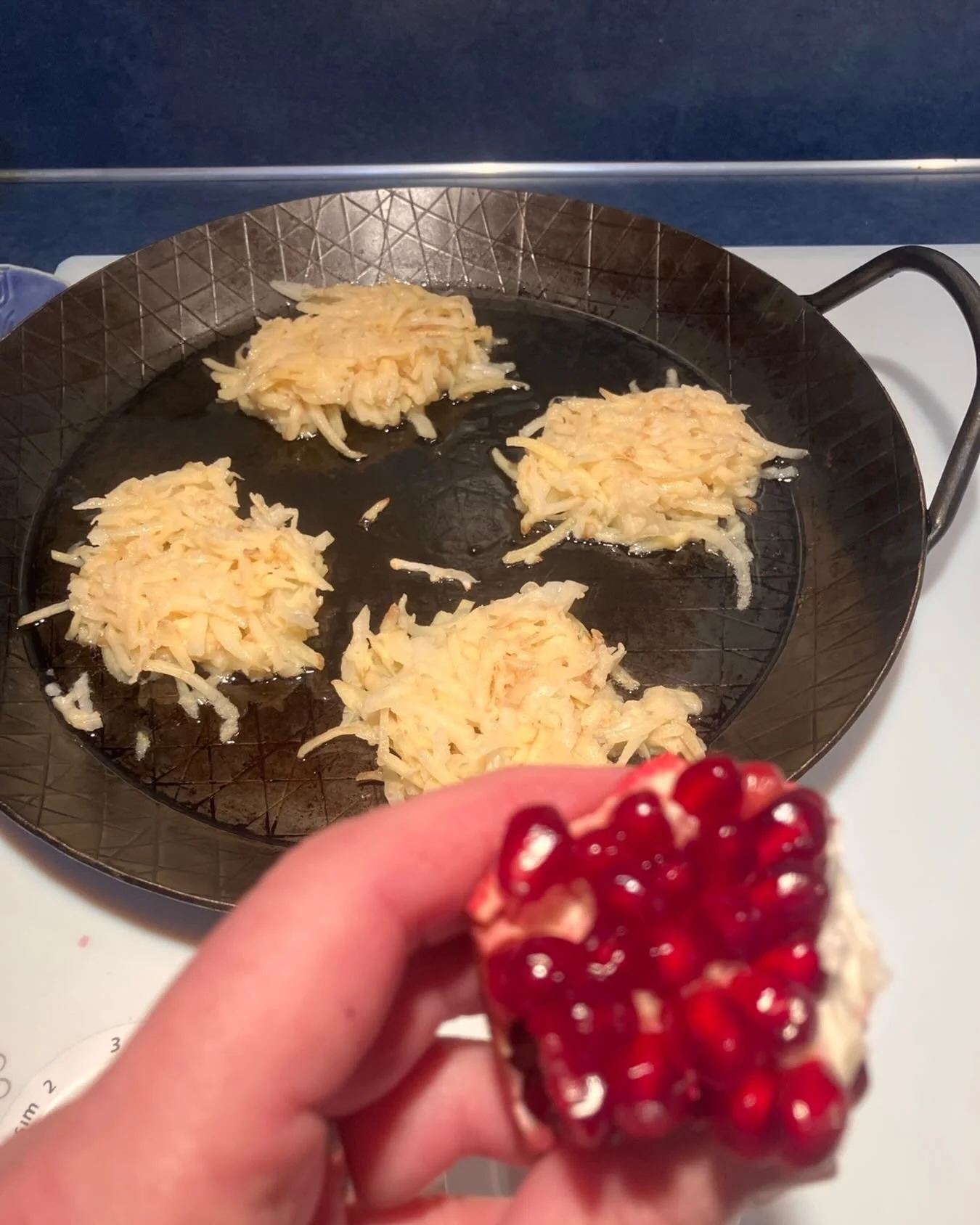 Supercharging my Jew powers by eating pomegranate while making latkes.