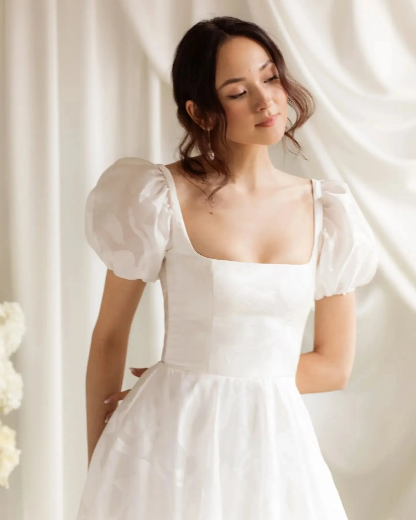 MEET LUMI // The brand-new @truvellebridal gown that gives you two looks in one; wear her with the detachable sleeve or keep it clean and simple without.⁠
⁠
Made in a soft satin jacquard with a soft square neckline, illusion back and just the right a