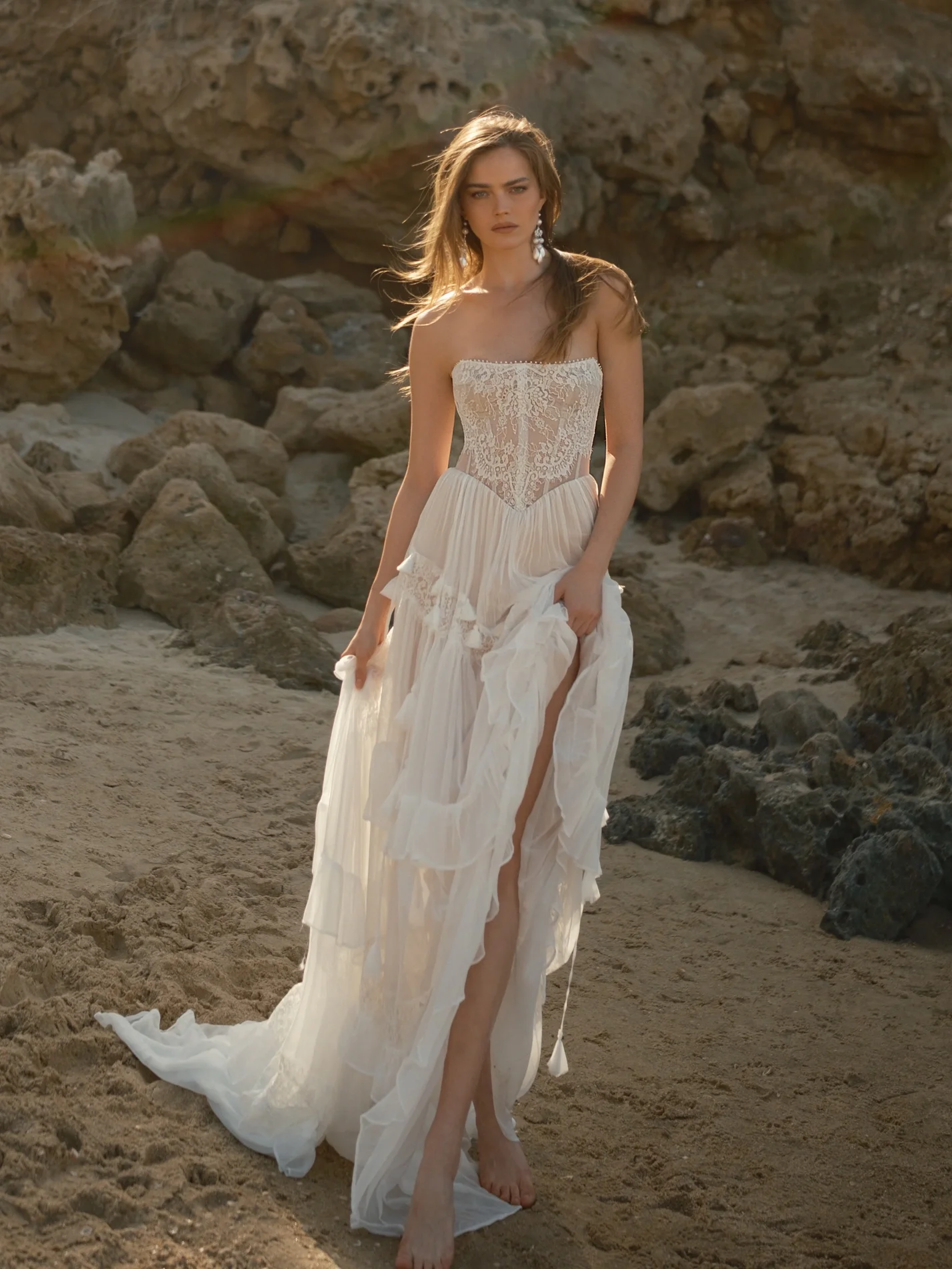 Strapless lace wedding dress by Rish Bridal with corset bodice and flowing skirt, featured in the Wind Whisperer collection at Heart Aflutter Bridal trunk show