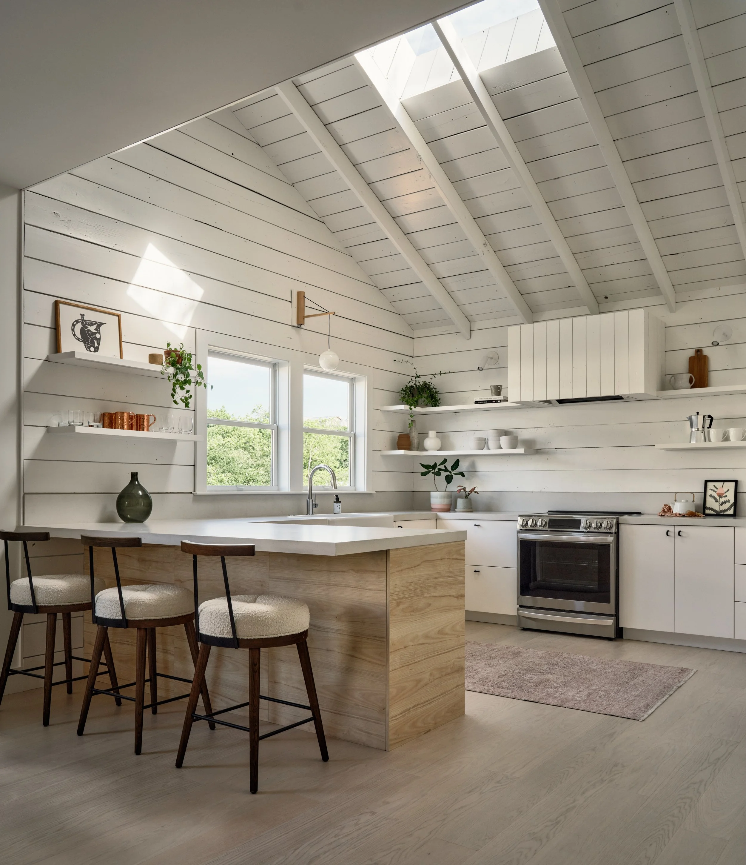  In the bustling outskirts of downtown Austin in the historic Castle Hill neighborhood, a steep, tricky lot was transformed by Forge Craft Architecture + Design, building a new, modern certified Passive House duplex behind an existing bungalow origin