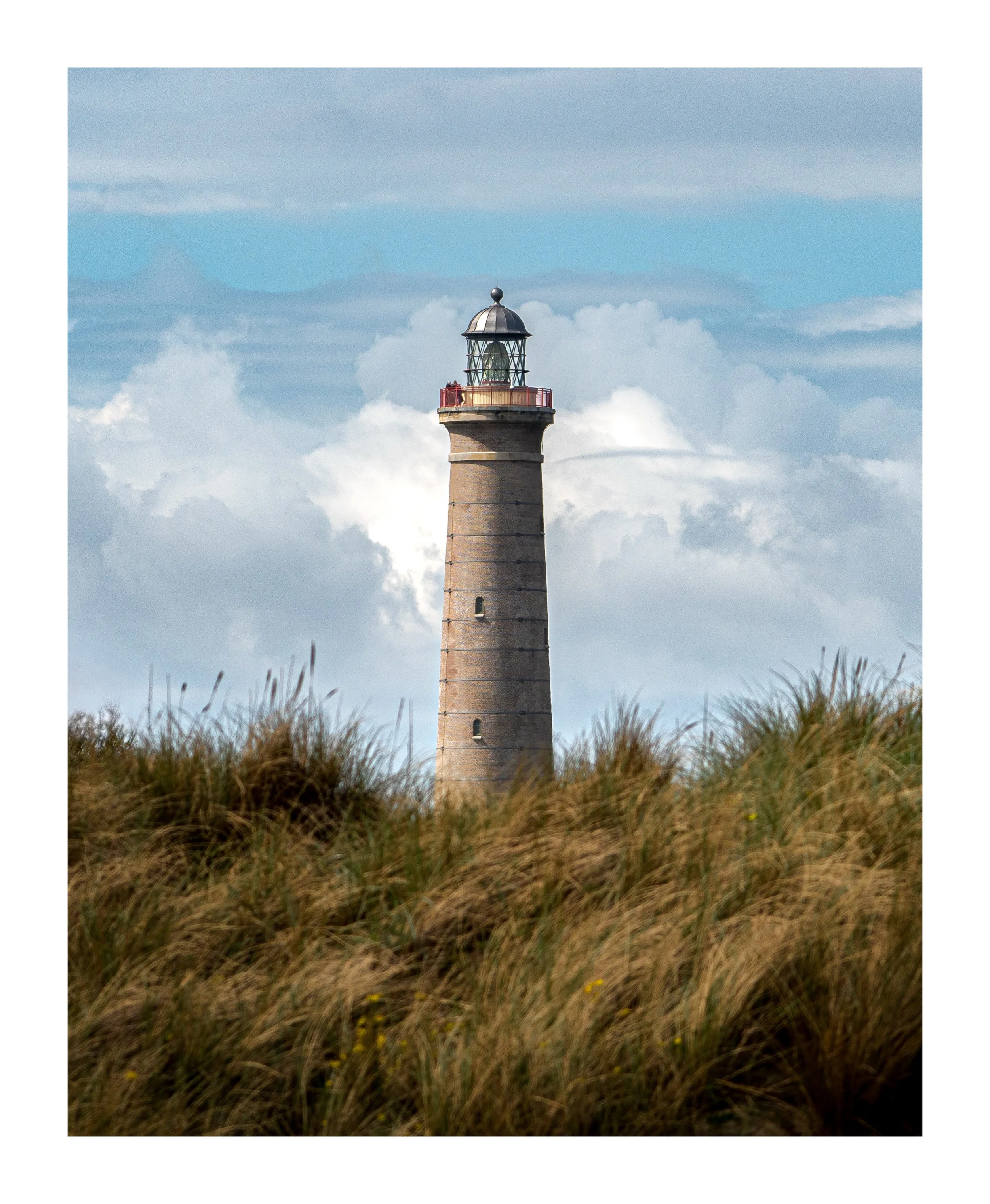 📍 Det Gr&aring; Fyr, Skagen, Denmark

Standing tall among the dunes, Det Gr&aring; Fyr has guided sailors along Denmark&rsquo;s northern coast for generations. Surrounded by wind-shaped grass and dramatic skies, it&rsquo;s one of Skagen&rsquo;s most