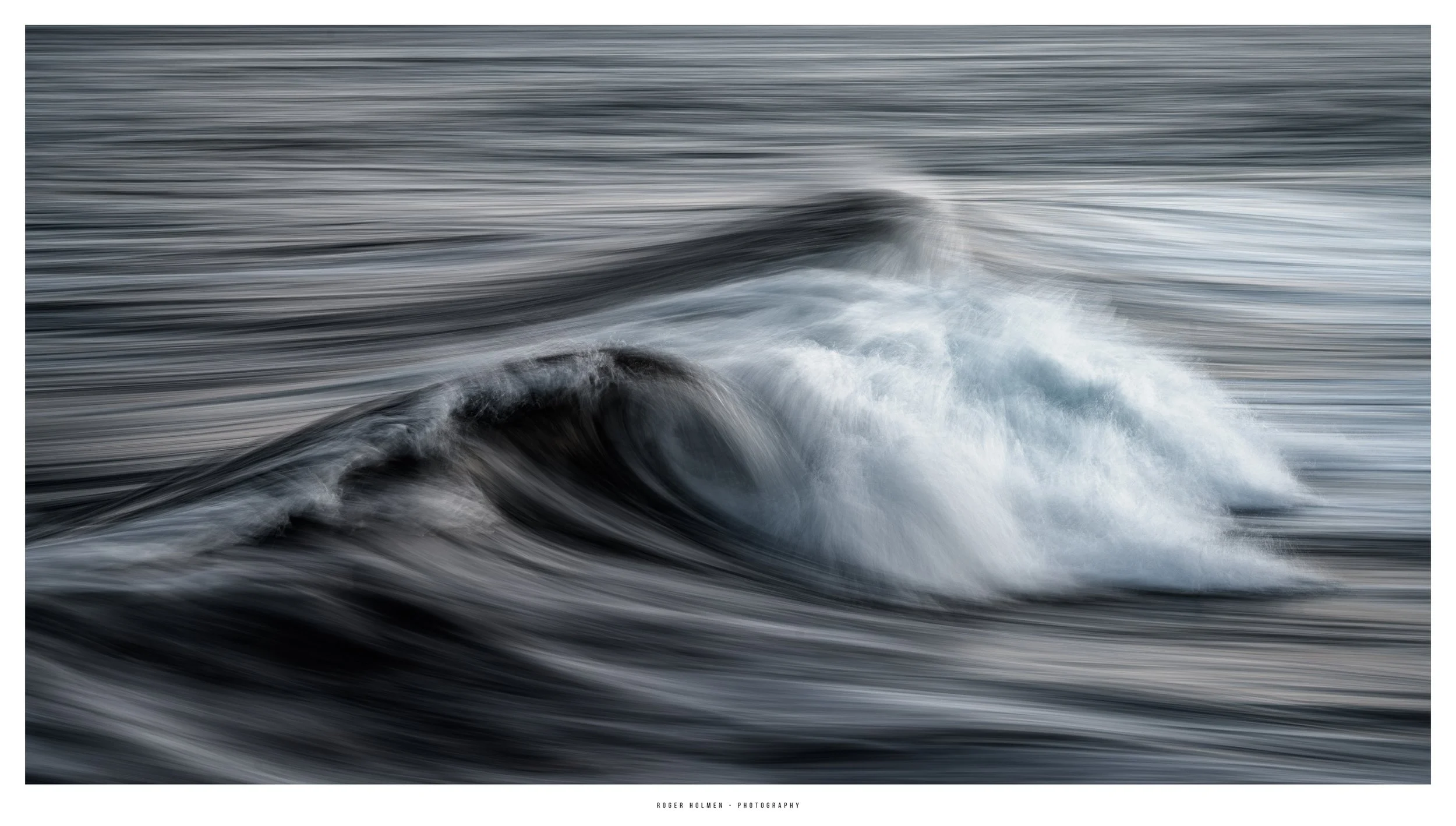 Blurred motion of ocean waves with white surf and dark water, creating an abstract depiction of the sea.